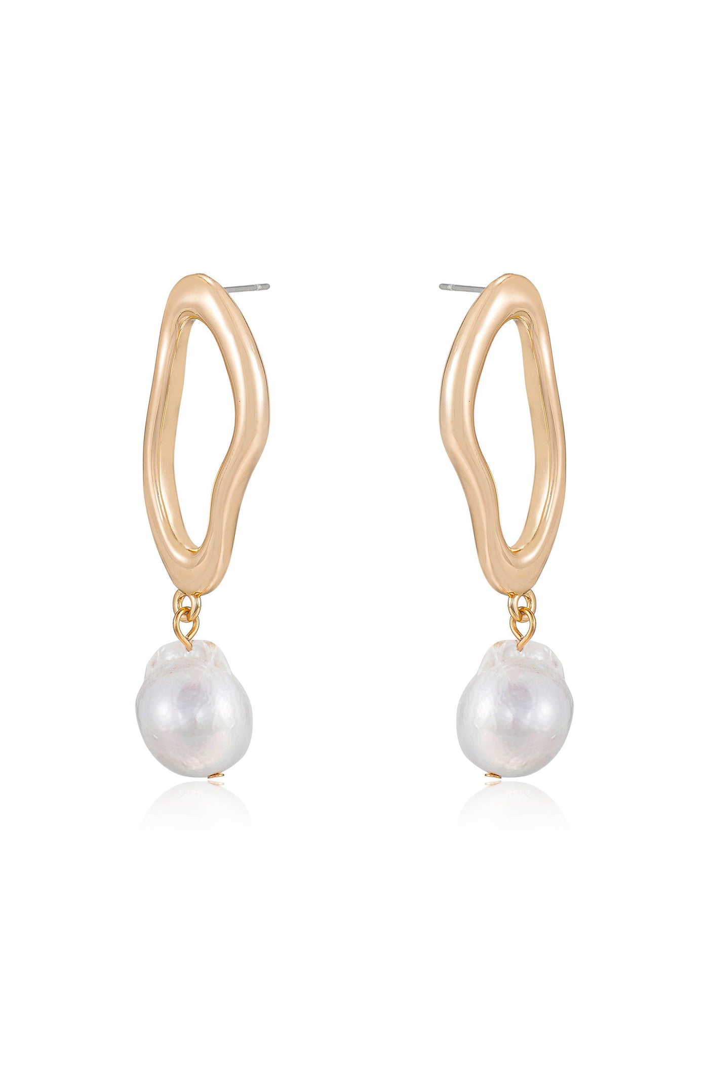 Gold hoop earrings feature an organic, wavy design with a dangling irregularly shaped white pearl. They are displayed against a simple, reflective background, emphasizing their elegance.