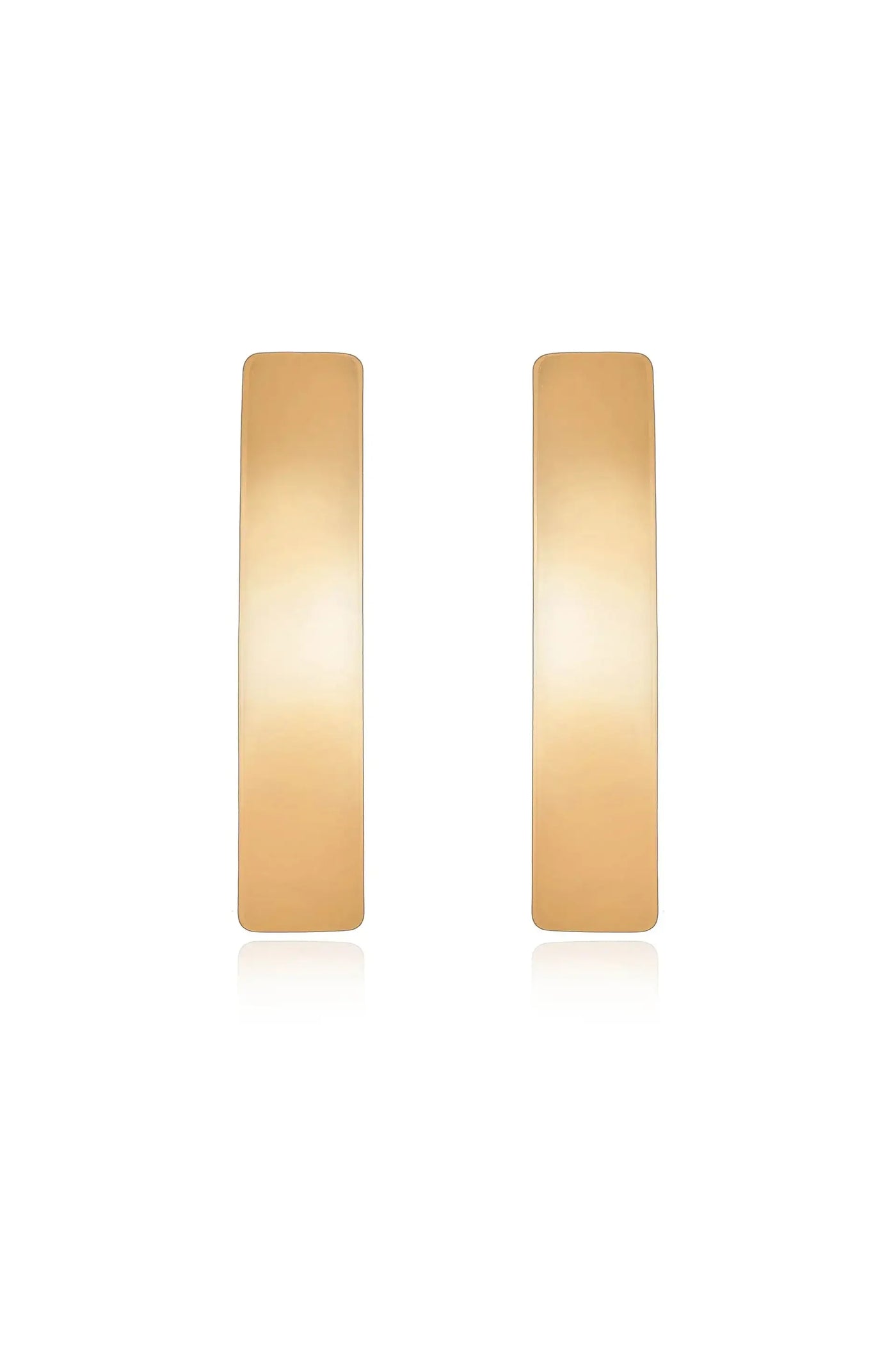 Two elongated, flat gold-colored earrings are displayed symmetrically against a white background, reflecting light softly to emphasize their smooth surface and minimalist design.