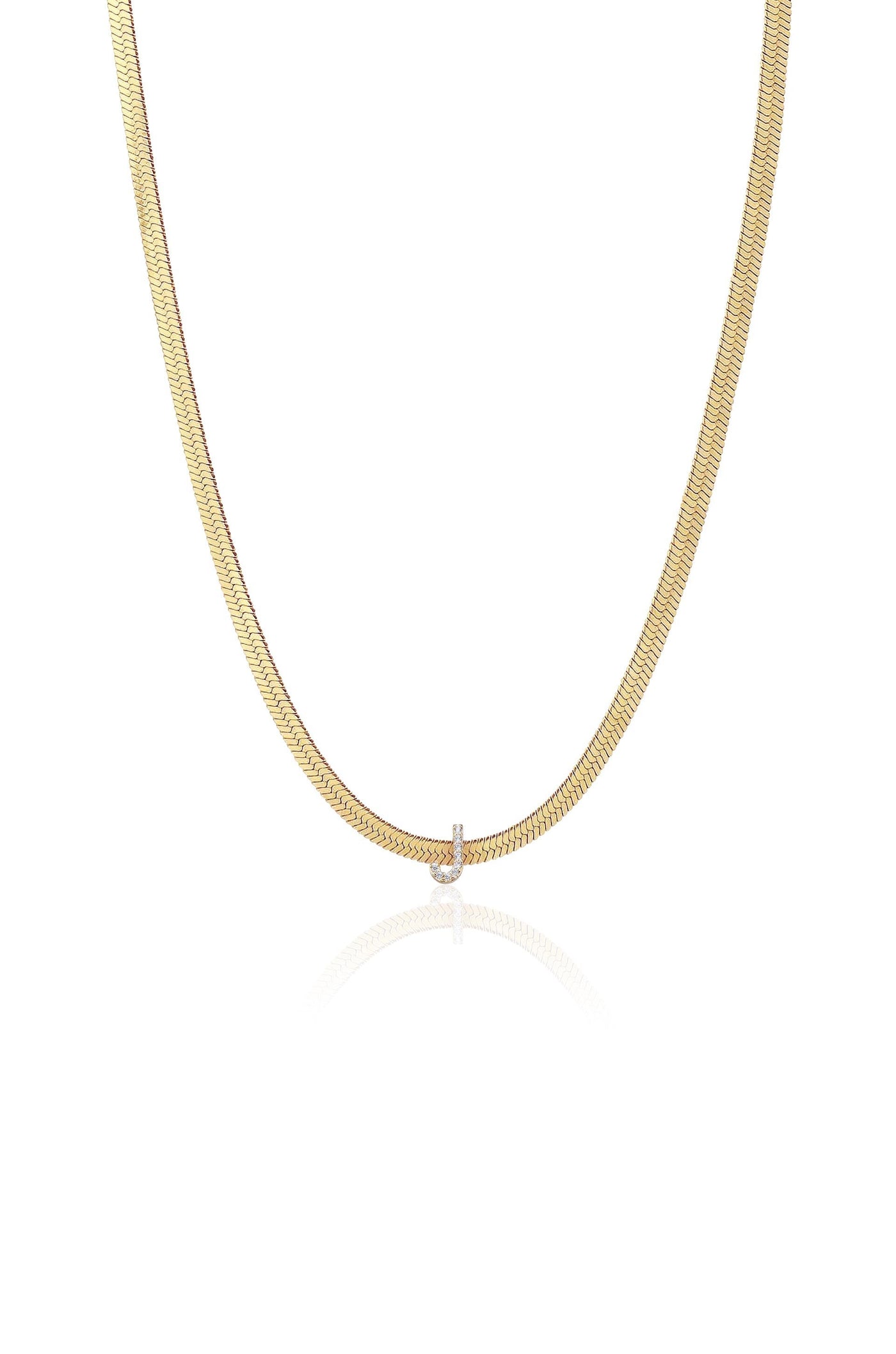A gold chain necklace hangs gracefully, featuring a smooth, flat design with a small diamond-like pendant at the center, set against a simple white background, reflecting a soft shine.
