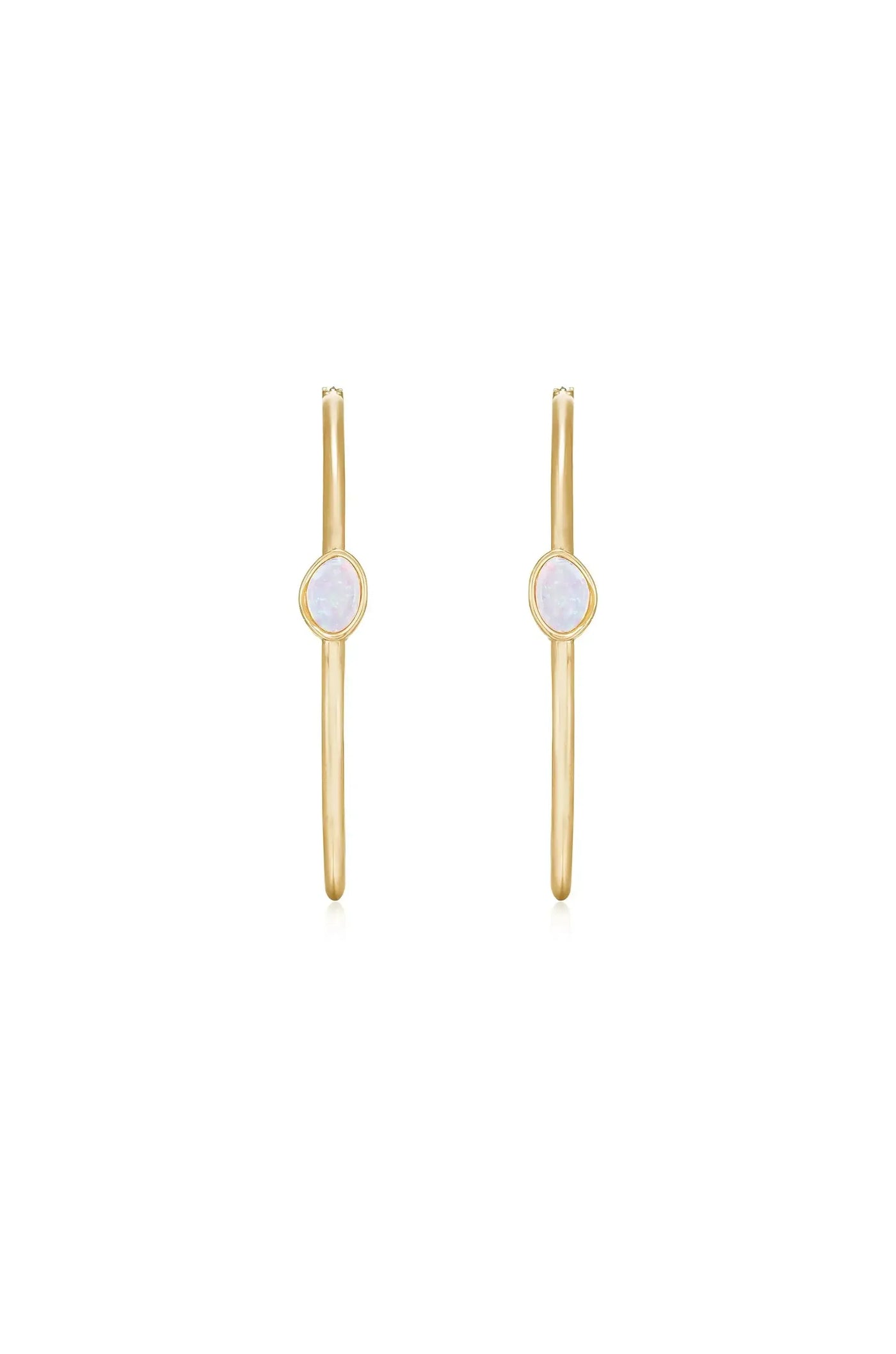 Gold hoop earrings feature an oval shaped gemstone in the center. They are displayed against a plain white background, emphasizing their simple and elegant design.