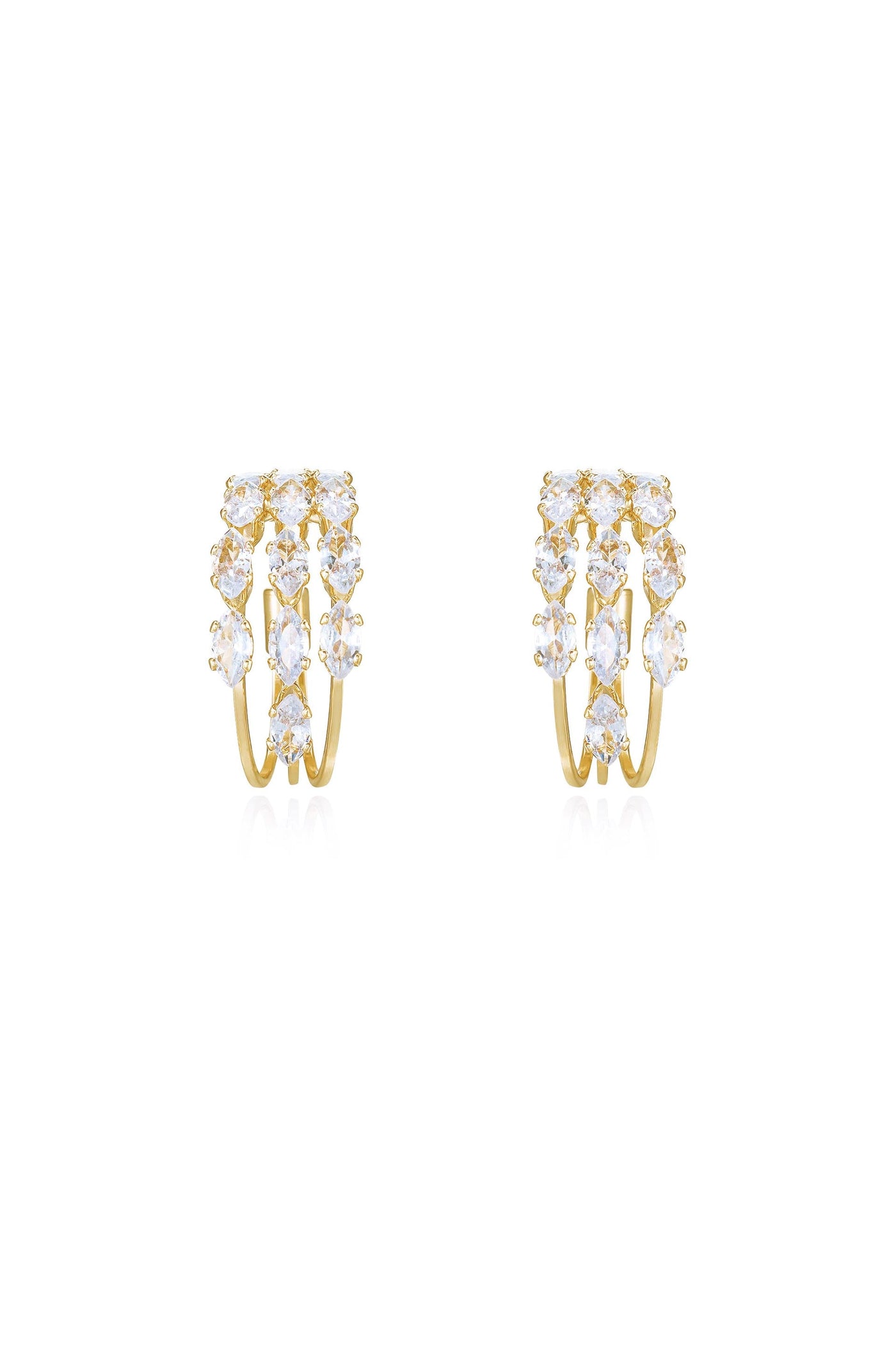 Gold hoop earrings adorned with multiple sparkling gemstones arranged in a cascading pattern, positioned against a clean, white background, showcasing their elegance and shine.