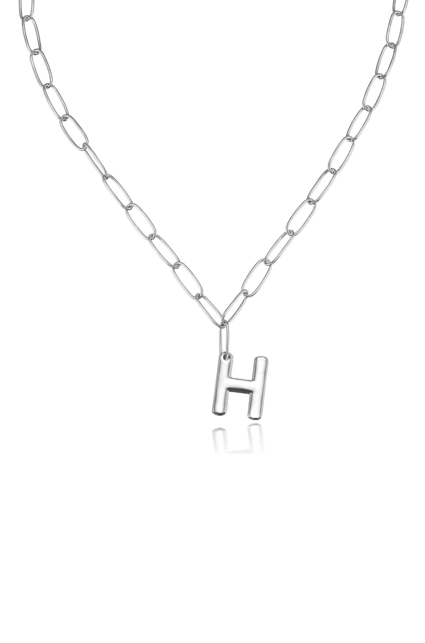 A silver chain necklace features an uppercase "H" pendant. The necklace hangs against a plain background, emphasizing its simple yet elegant design.