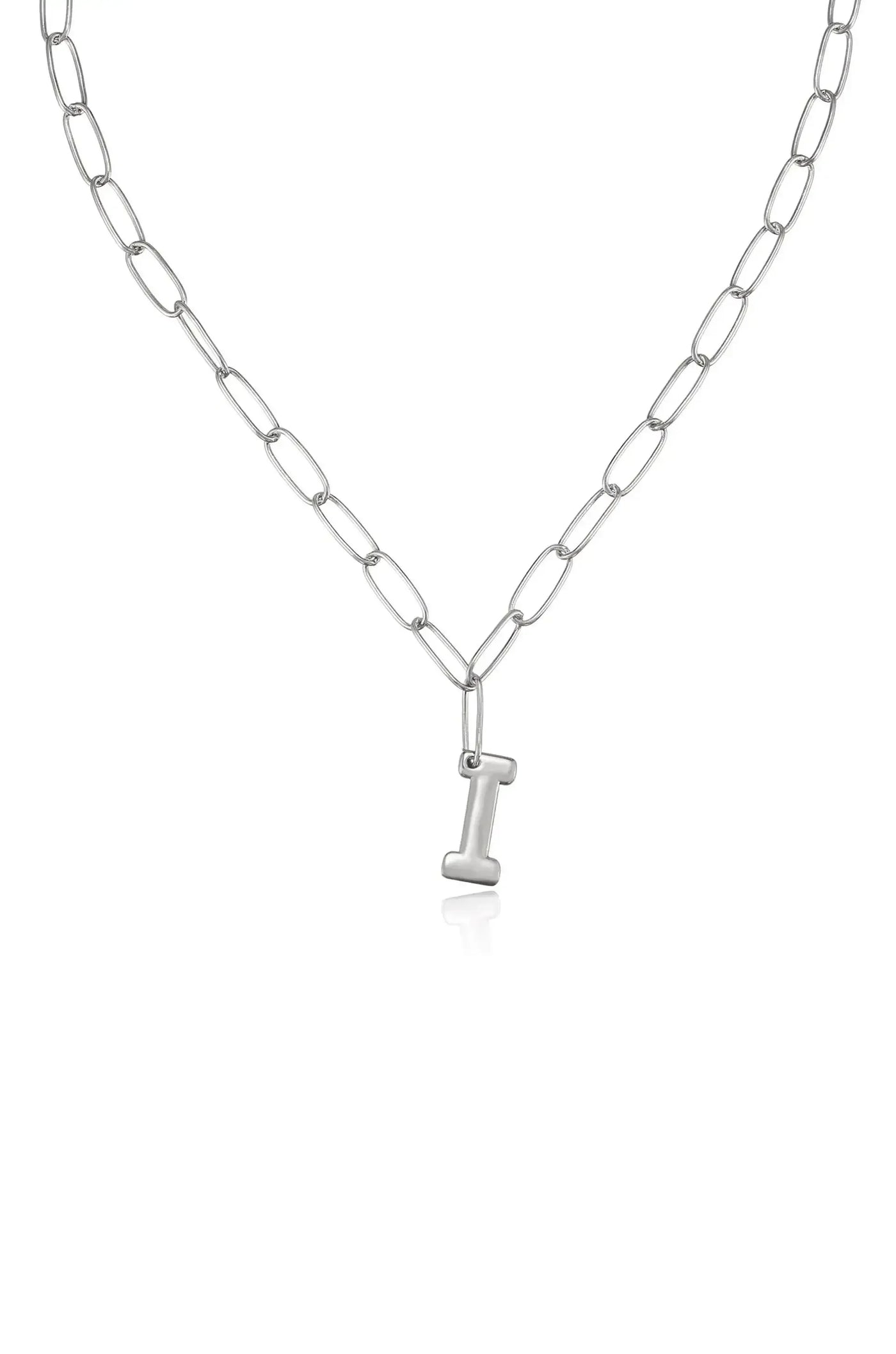 A silver chain necklace features elongated links and a prominent letter "I" pendant hanging delicately at its center, set against a plain white background.