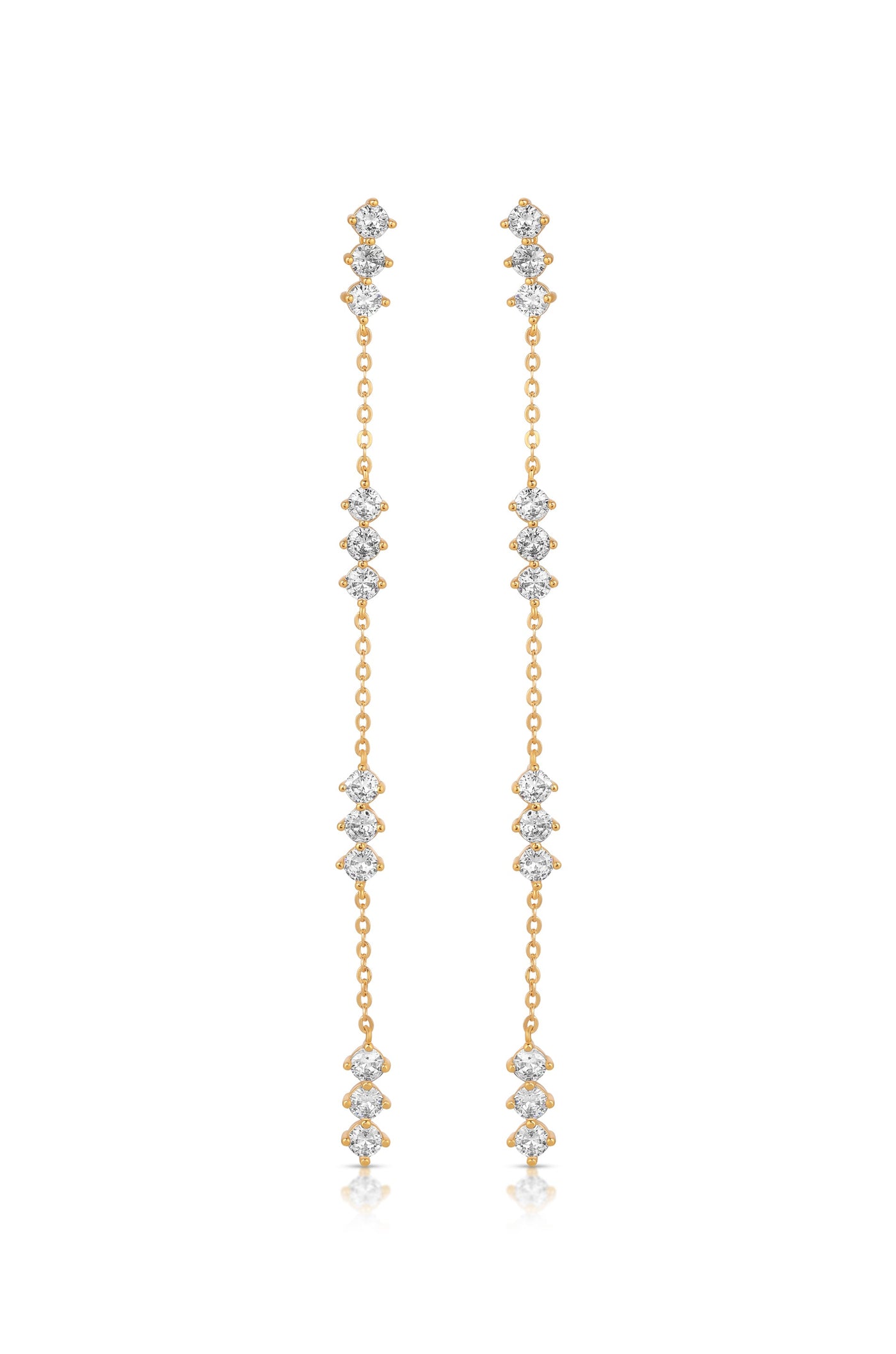 Dangling earrings made of gold feature multiple interconnected diamond-like gemstones, creating a shimmering effect against a clean, neutral background. The design emphasizes elegance and sophistication.