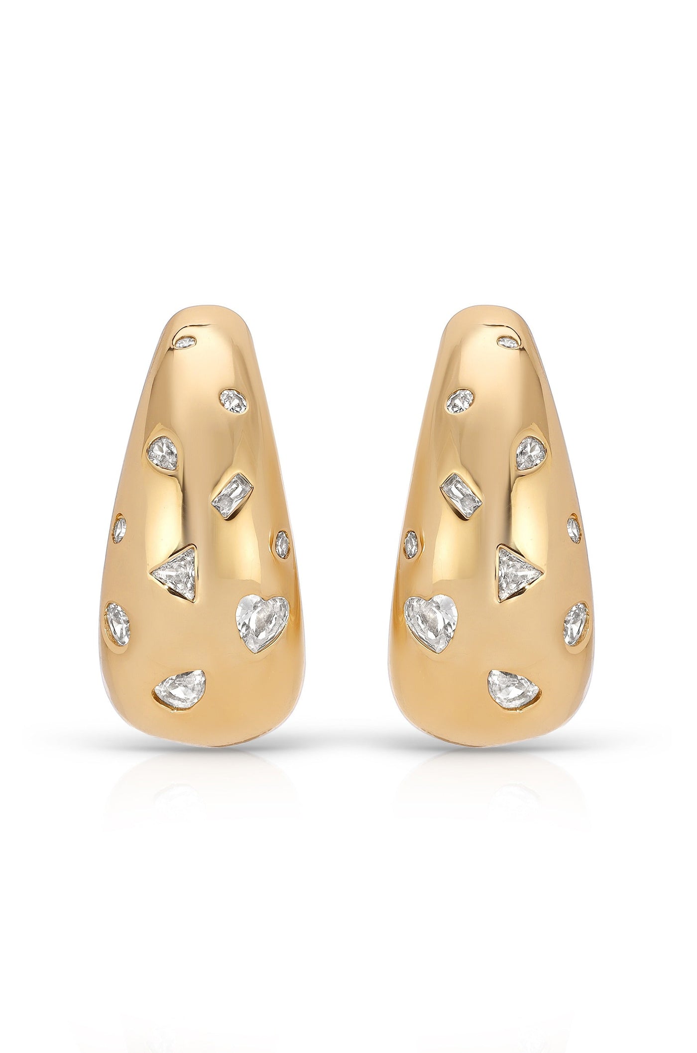 Two gold-tone earrings are displayed, featuring a smooth surface adorned with variously shaped, sparkling gemstones. They rest against a clean, white background, showcasing their elegant design.