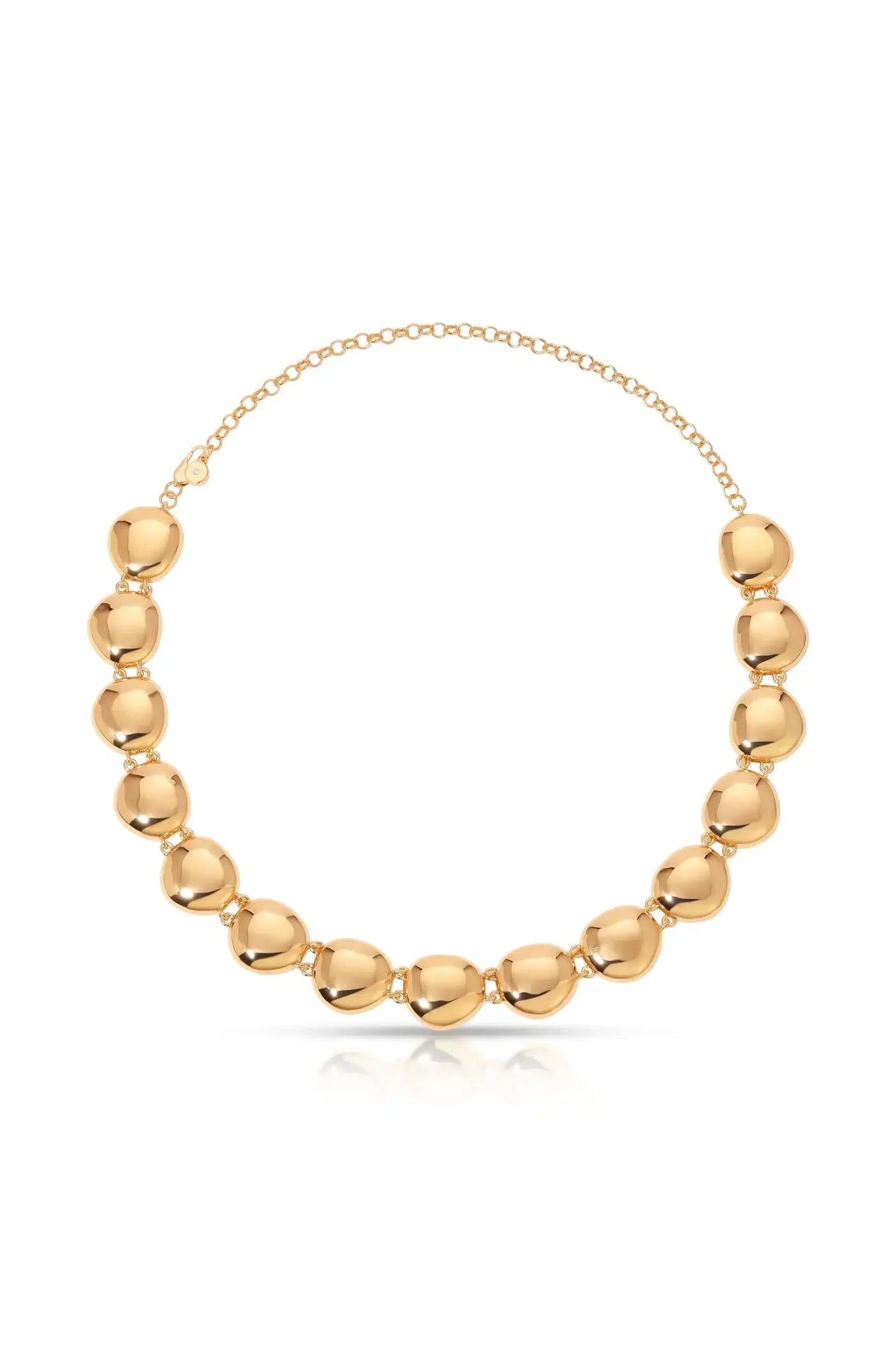 A polished golden necklace features a series of smooth, rounded beads joined by links. It rests on a reflective surface, highlighting its shiny texture and elegant design.