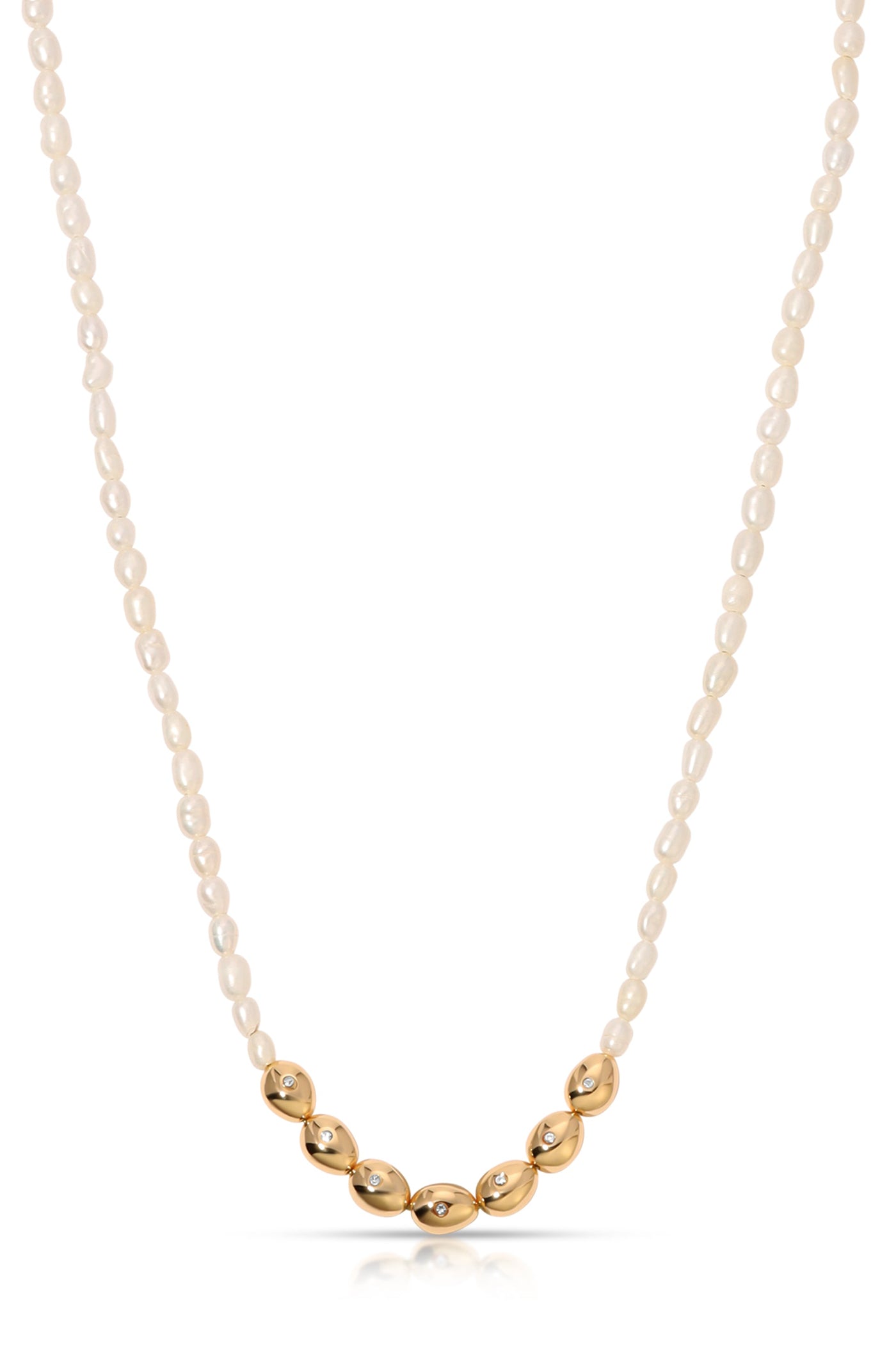 A pearl necklace combines small, glossy white pearls with larger gold oval-shaped beads, some adorned with sparkling stones, elegantly displayed against a plain background.