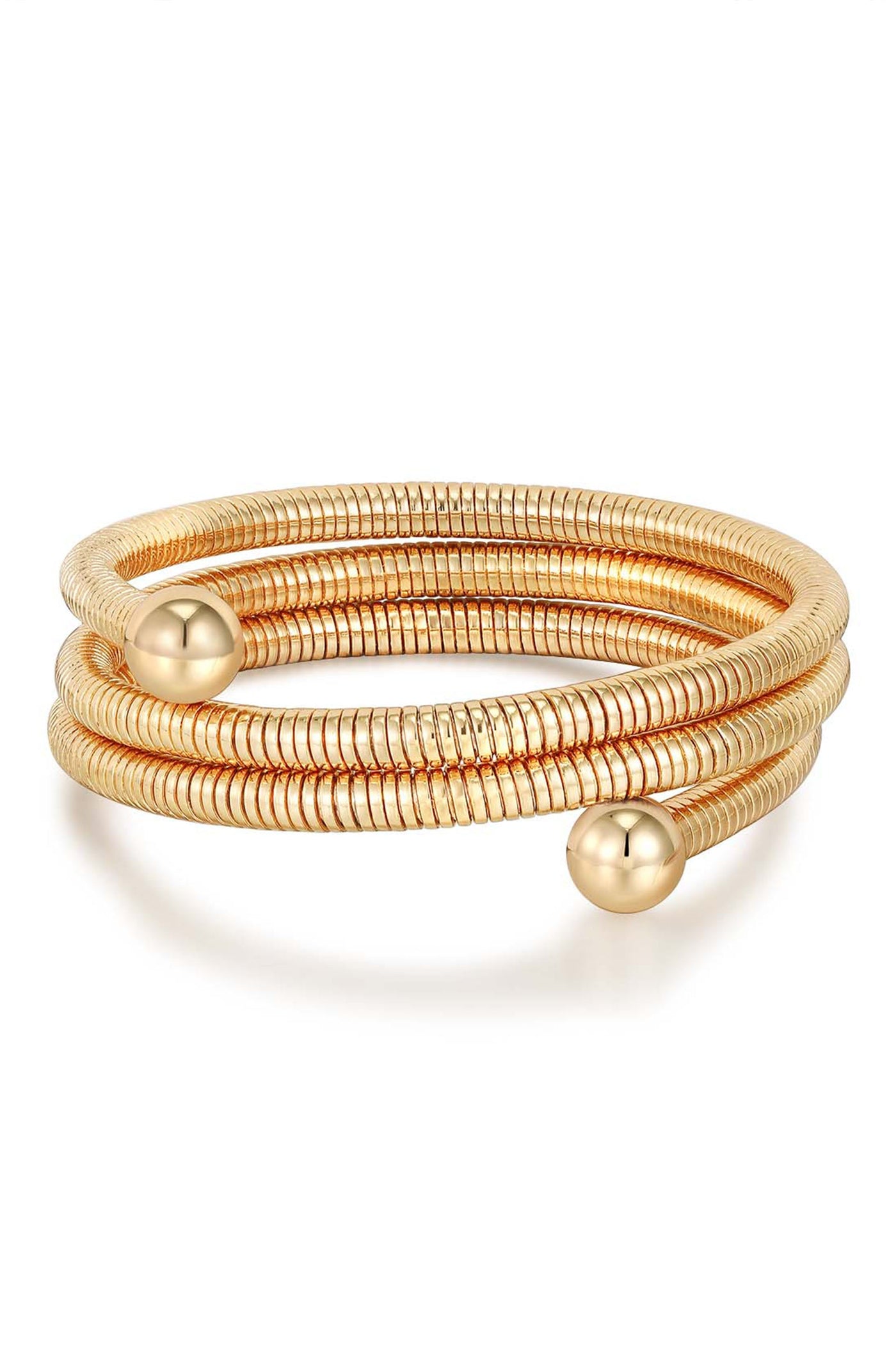 A spiraled gold bracelet features two spherical ends, coiling around itself in a stylish design. It is set against a plain white background, emphasizing its reflective surface.