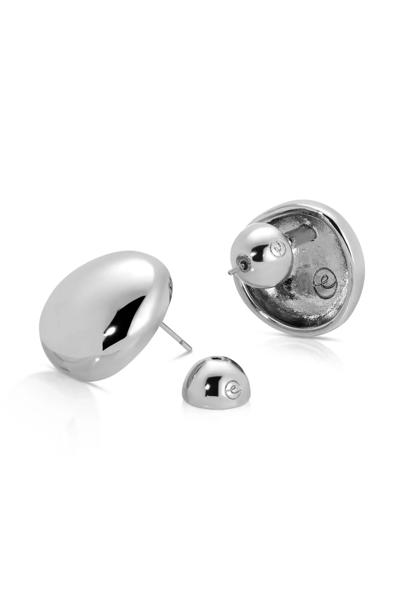 A pair of shiny silver earrings are displayed. One earring features a larger, smooth, oval shape, while the other is a small, rounded piece. Both are set against a plain white background.