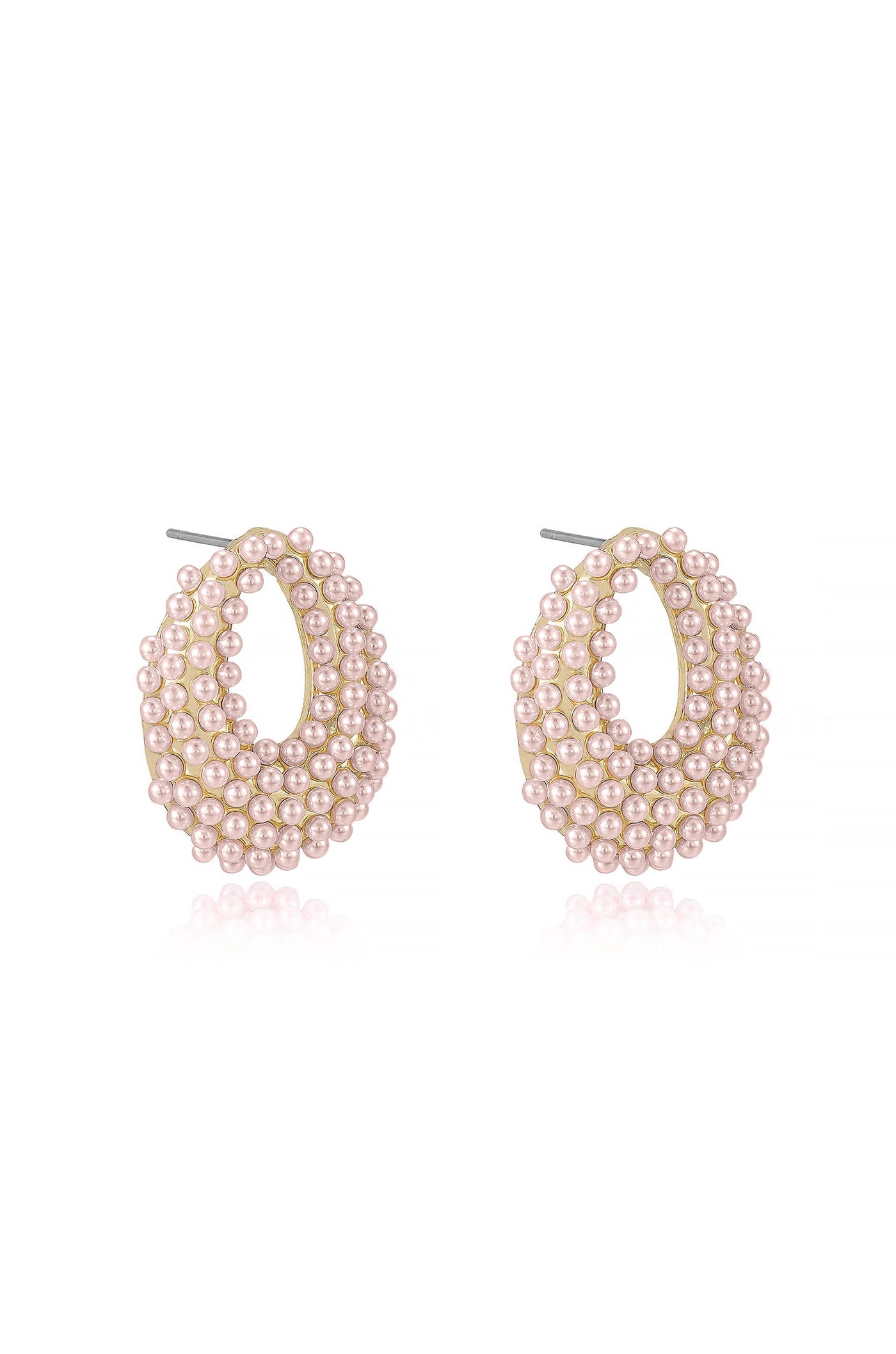 Pearl earrings are displayed, showcasing a large oval shape adorned with numerous small pink pearls. The setting appears to be metallic, creating a reflective background that enhances the jewelry's elegance.
