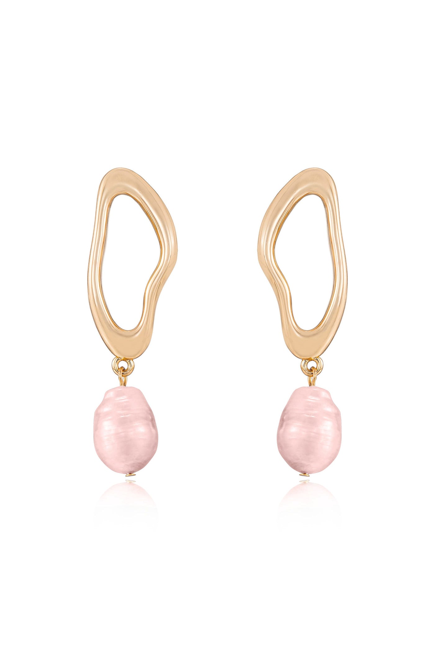 Gold earrings feature a wavy, abstract design holding a pink, irregular-shaped pearl. The earrings hang vertically, showcasing their unique style against a simple, light background.