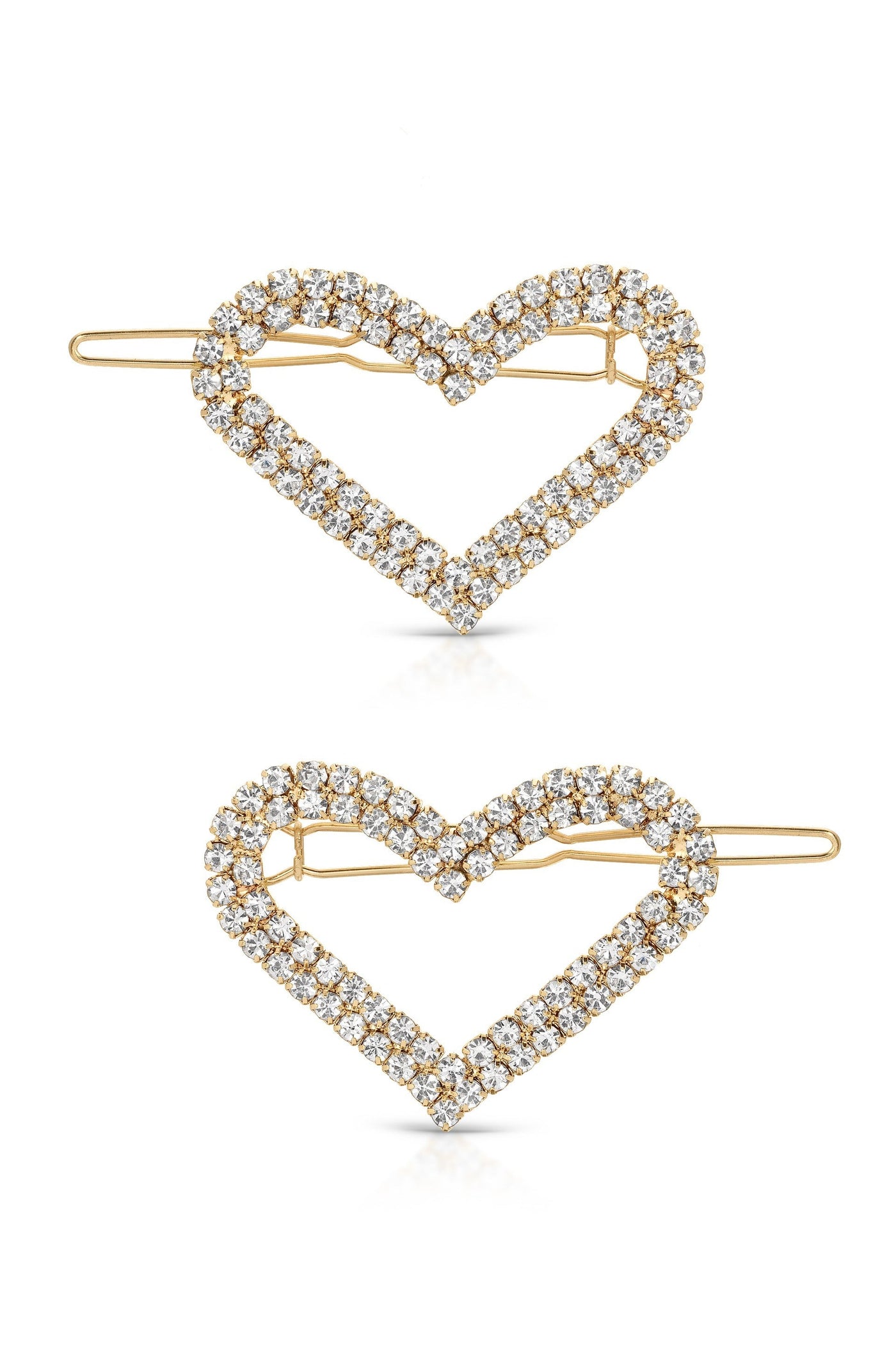 Two heart-shaped hair clips, embellished with sparkling rhinestones and a gold-toned frame, are positioned one above the other, reflecting light and showcasing a decorative design for hair accessories.