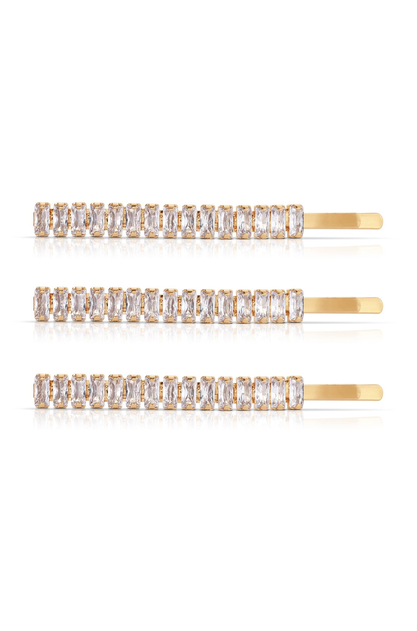 Three gold hairpins adorned with rectangular, clear gemstones are arranged horizontally against a white background, reflecting light and showcasing their elegant design.