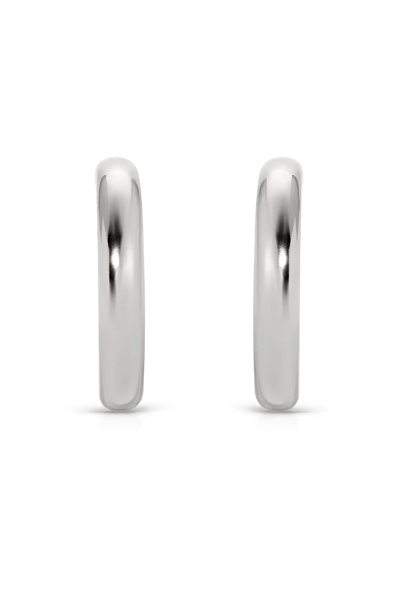 Two polished silver hoop earrings stand upright on a white background, reflecting light. Their smooth, rounded edges and shiny surface suggest a simple yet elegant design for adornment.