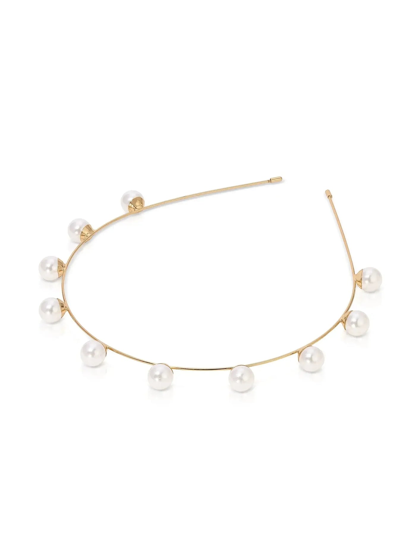 A delicate gold necklace features evenly spaced pearls adorning a slender, curved chain. It rests on a reflective white surface, highlighting its elegant and modern design.