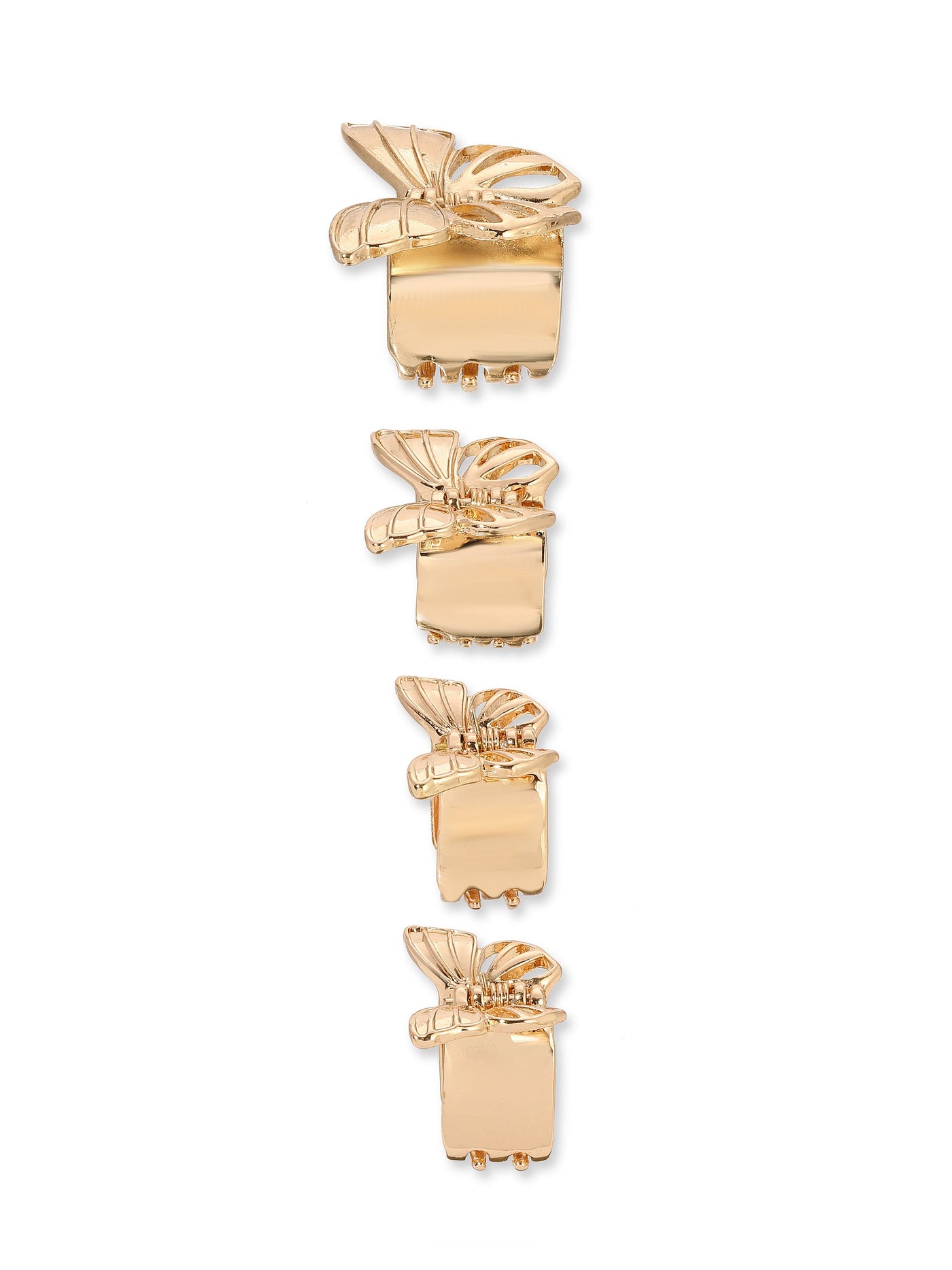 Four golden hair clips are arranged vertically. Each clip features a decorative bow design at the top. The clips sit against a plain white background, emphasizing their shine and intricate details.