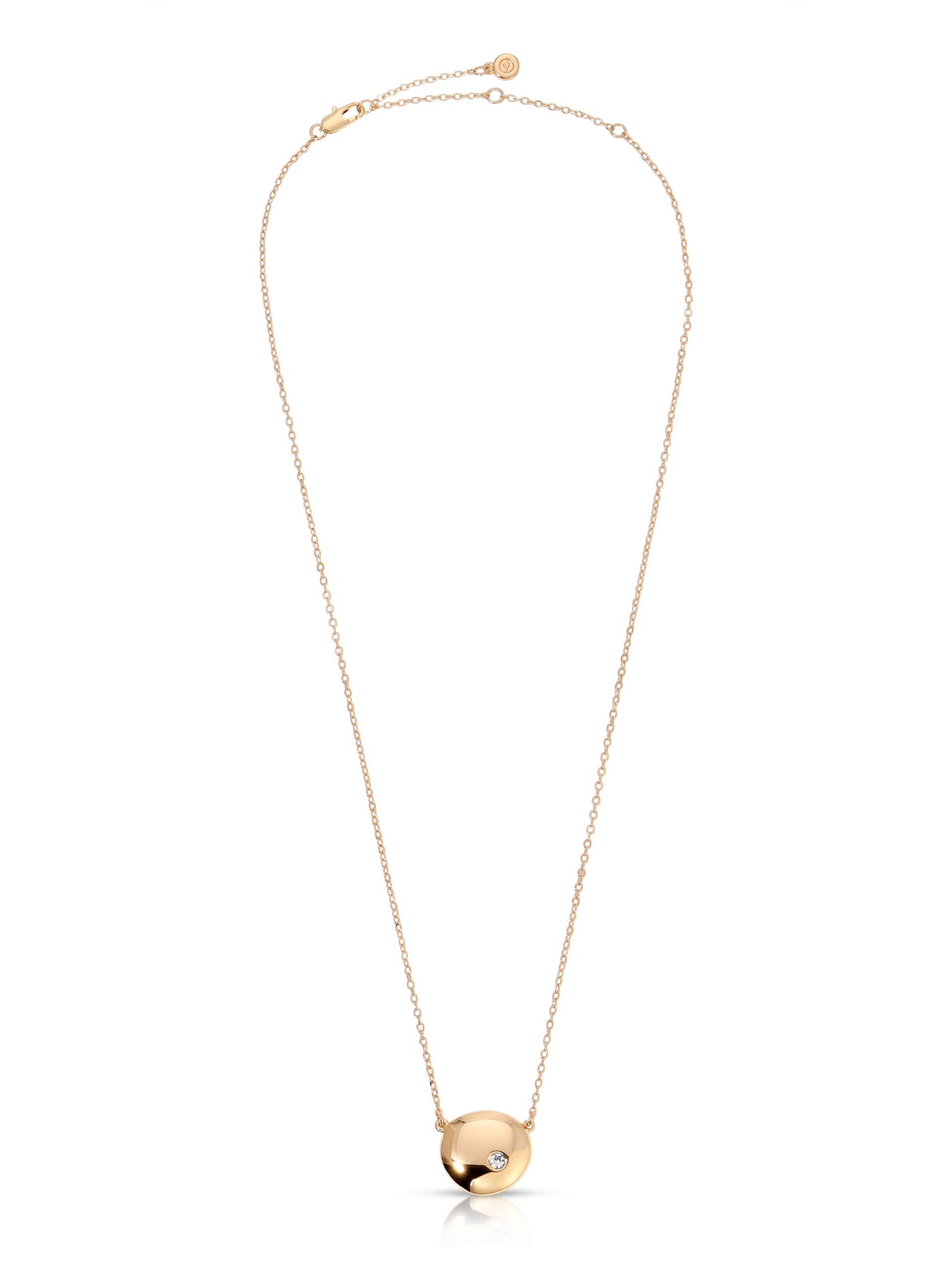 A delicate gold necklace features a round pendant with a small embedded diamond. It hangs from a fine, linked chain and is set against a neutral background, highlighting its elegance.