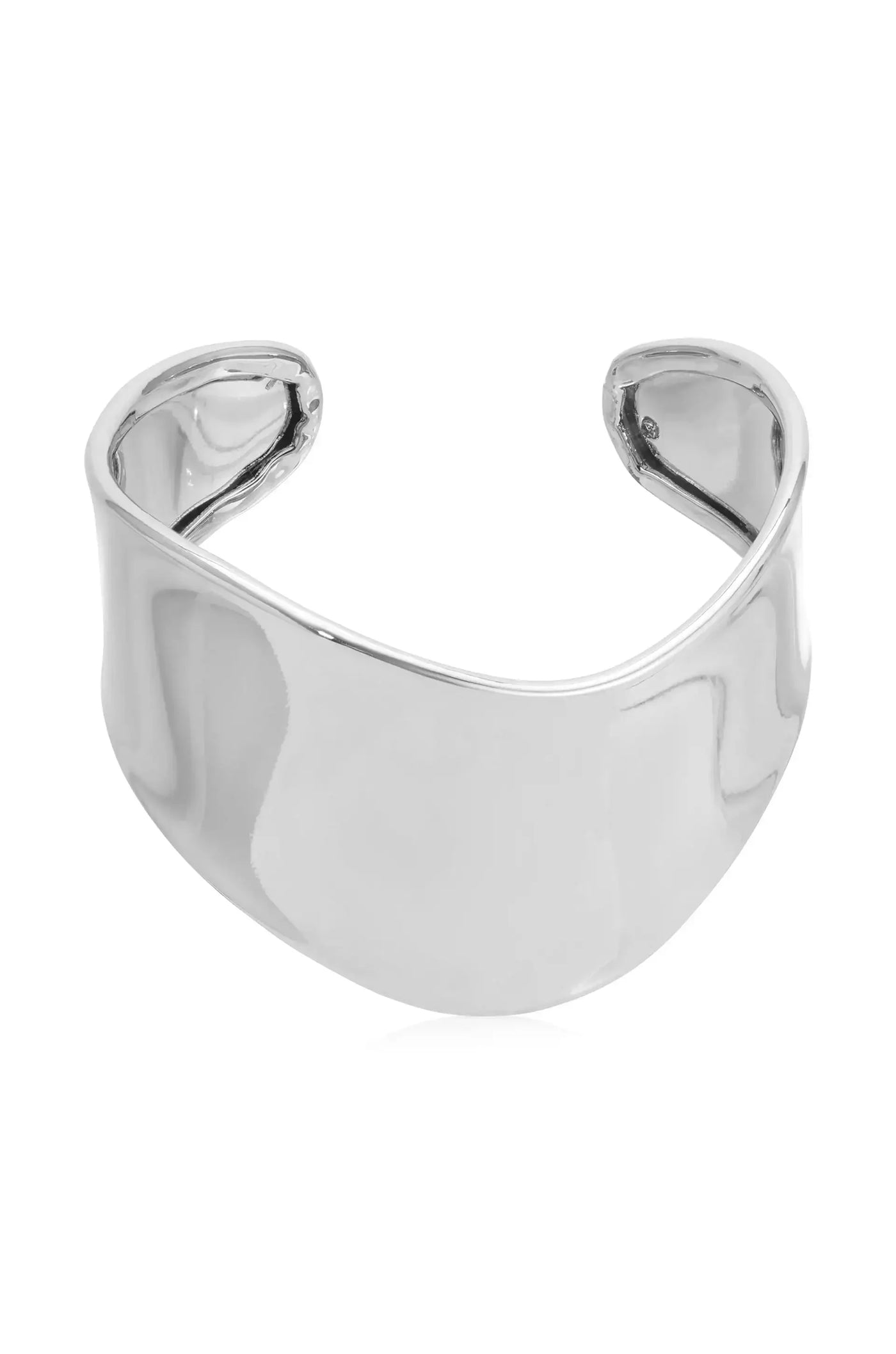 A shiny silver cuff bracelet rests horizontally, showcasing its smooth and reflective surface, with open ends allowing for adjustment. The background is neutral, emphasizing the bracelet's design.