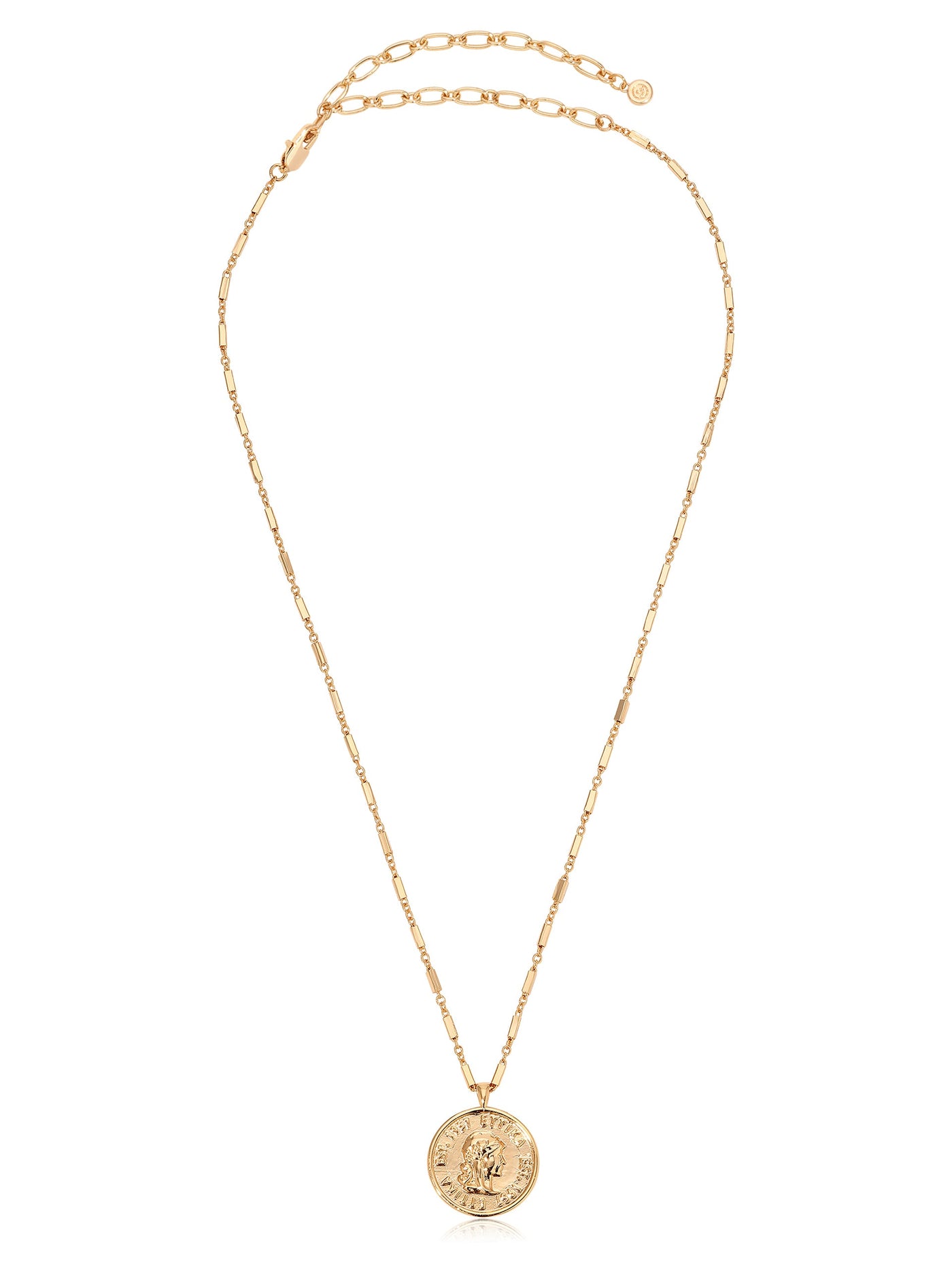 A gold necklace features a delicate chain with an ornate circular pendant displaying a detailed design. The necklace appears elegant and is set against a neutral background.
