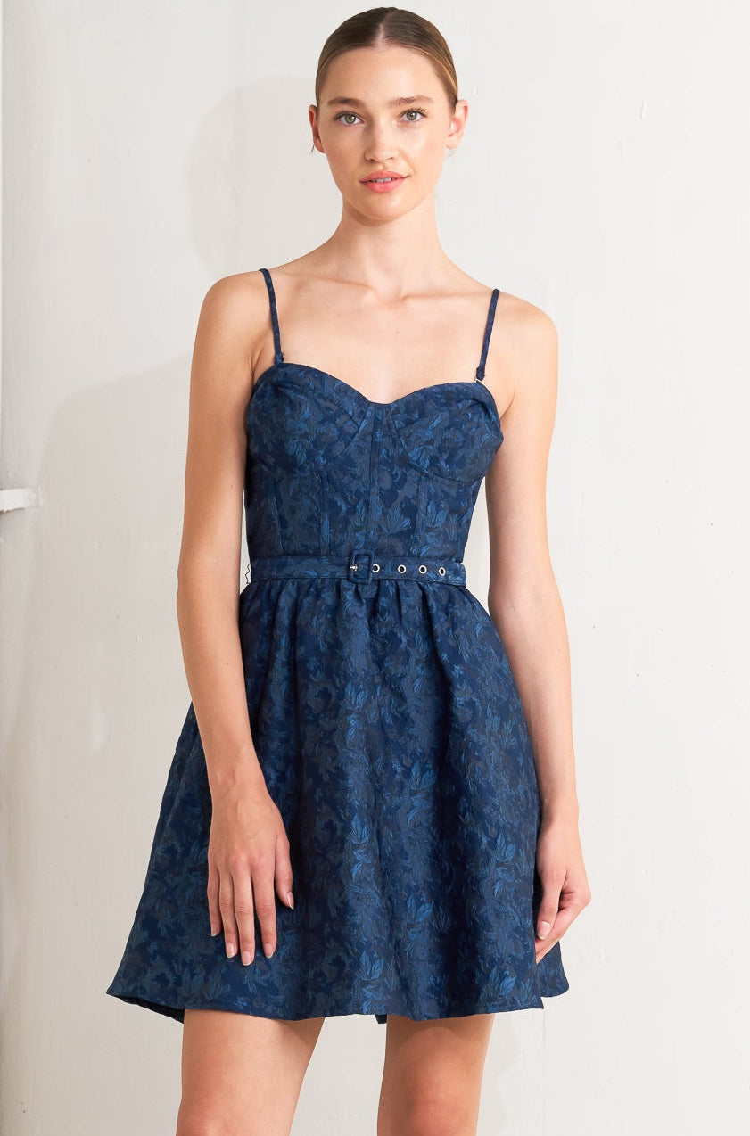 Woman wearing a blue dress against a white background