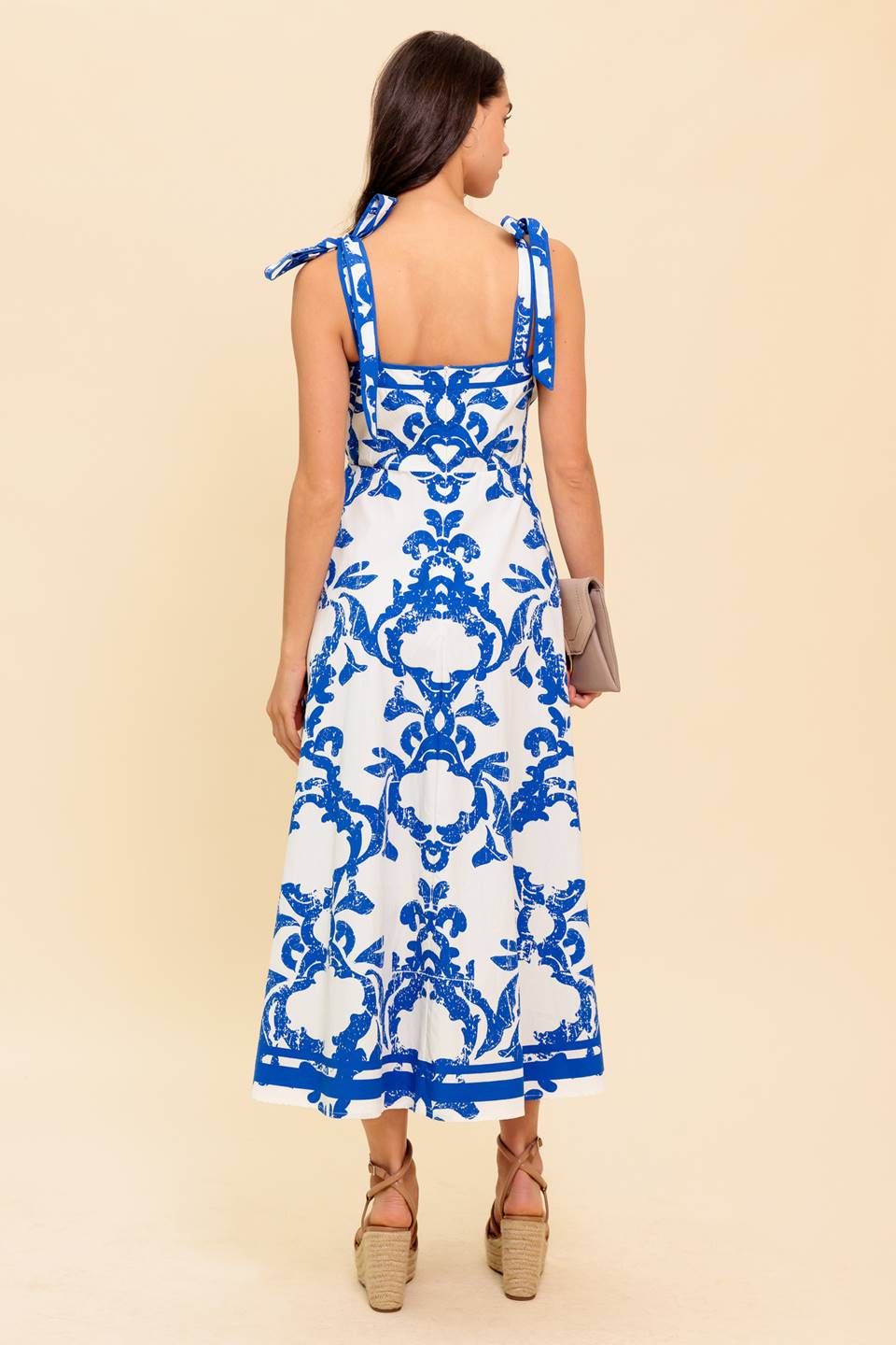 Blue and white floral midi dress with a straight neckline, shoulder straps, and a circle skirt.