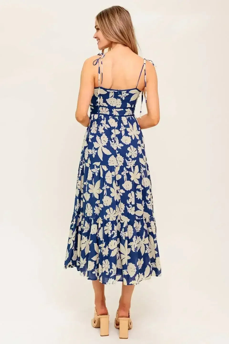 Blue floral midi dress with a sweetheart neckline, shoulder tie, waist yoke, tiered skirt, and back zipper closure.