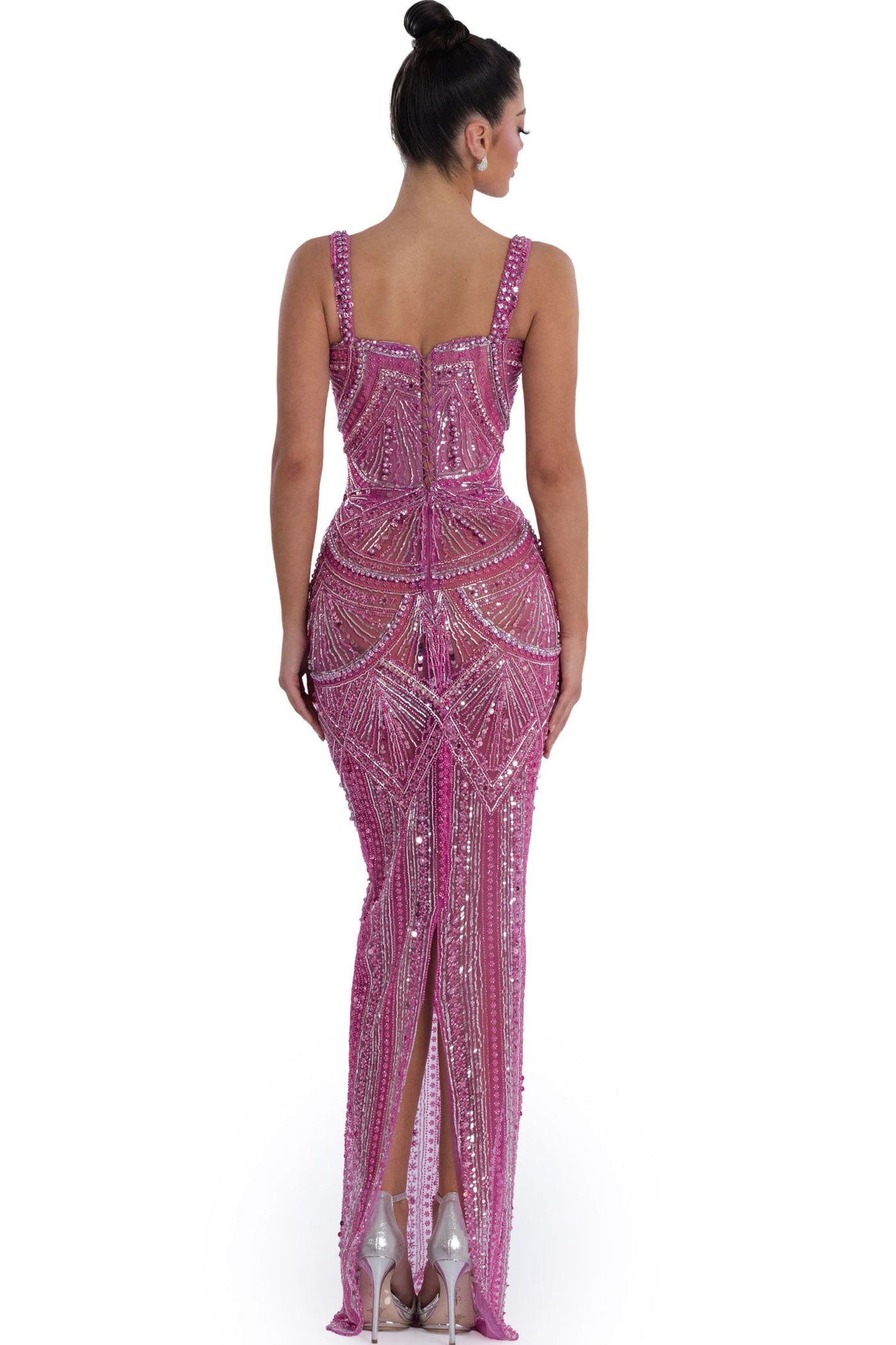 Woman wearing a pink beaded evening gown on a white background.