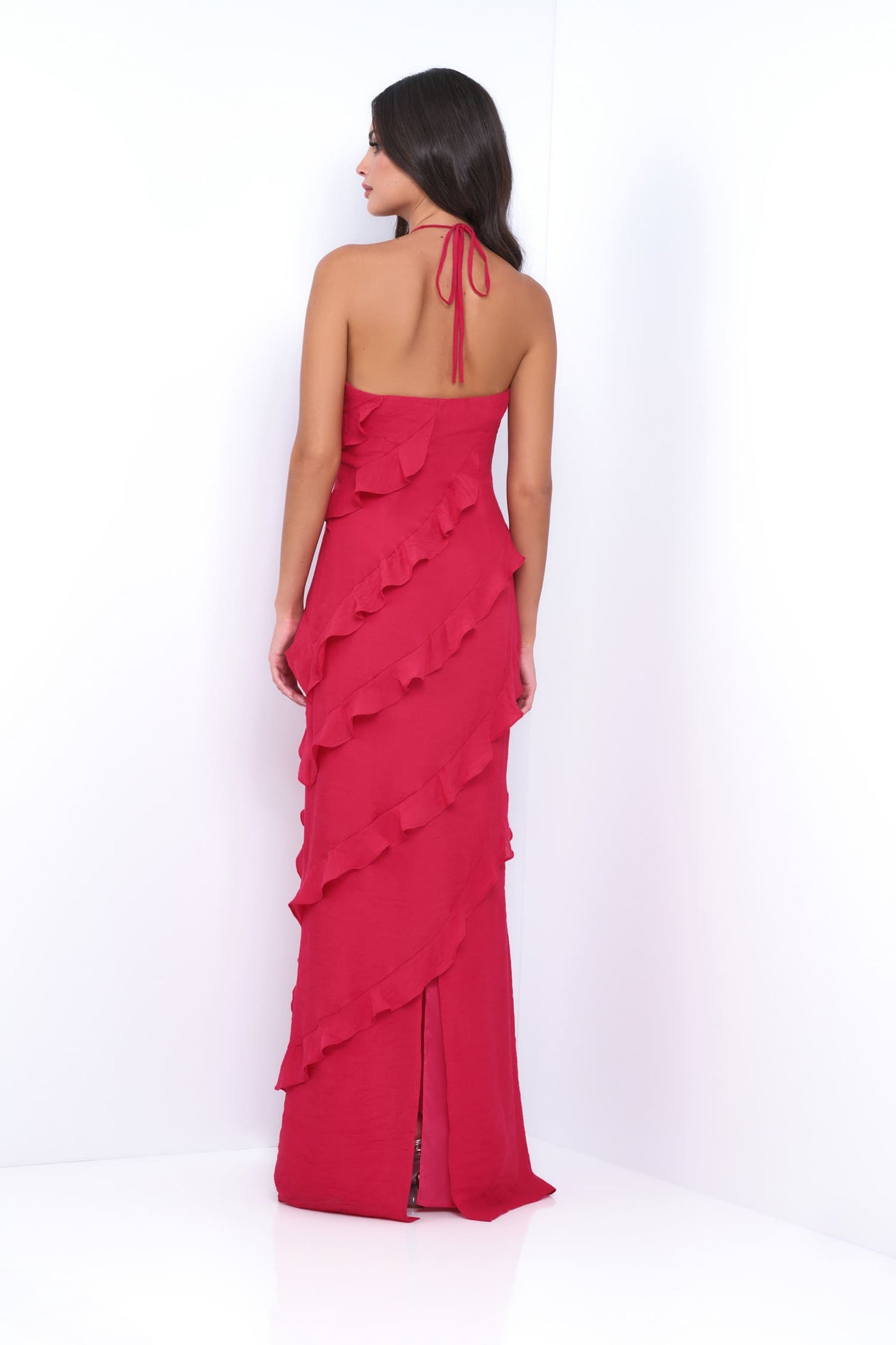 Woman wearing a red ruffled dress on a white background