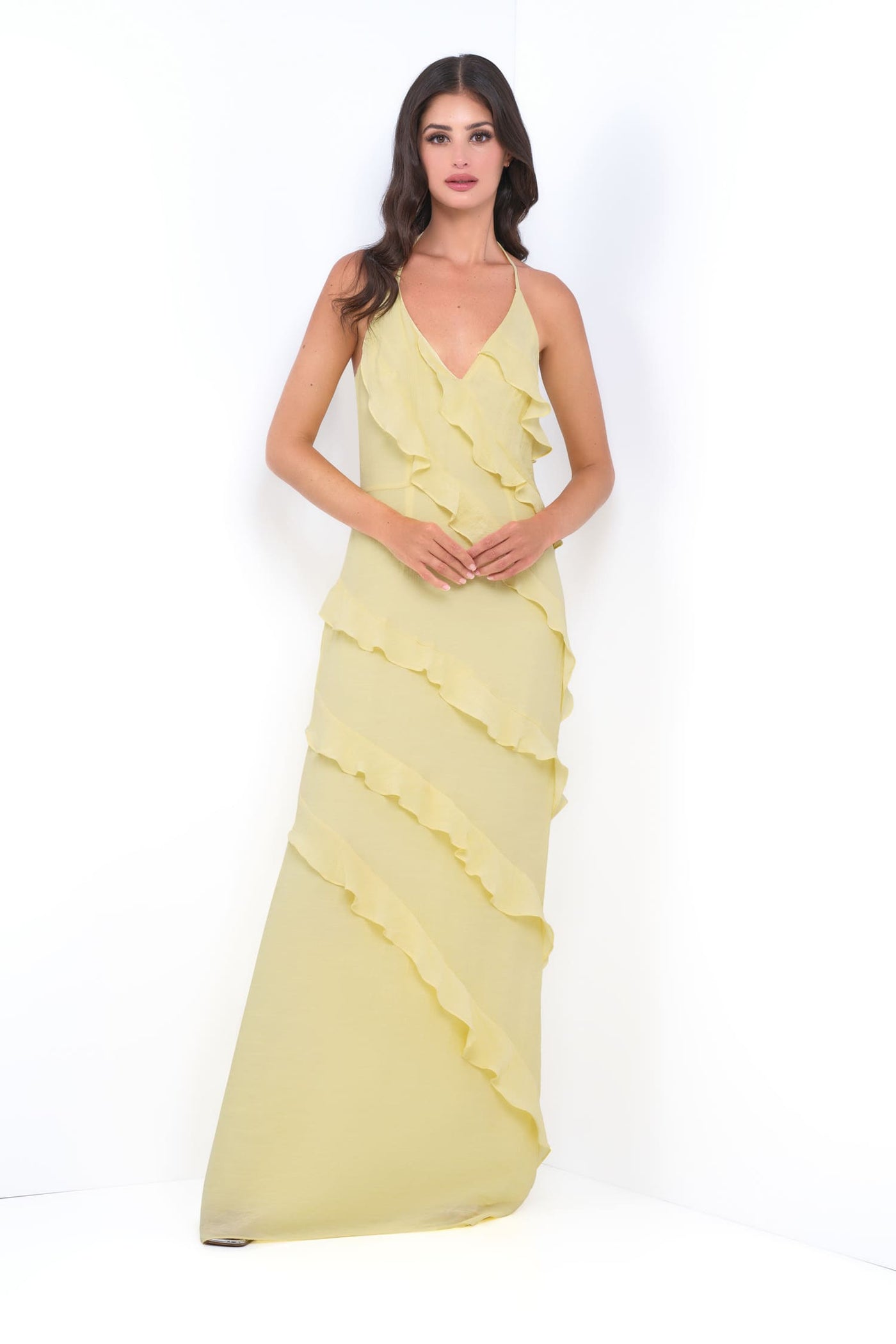 Woman wearing a yellow evening gown on a white background
