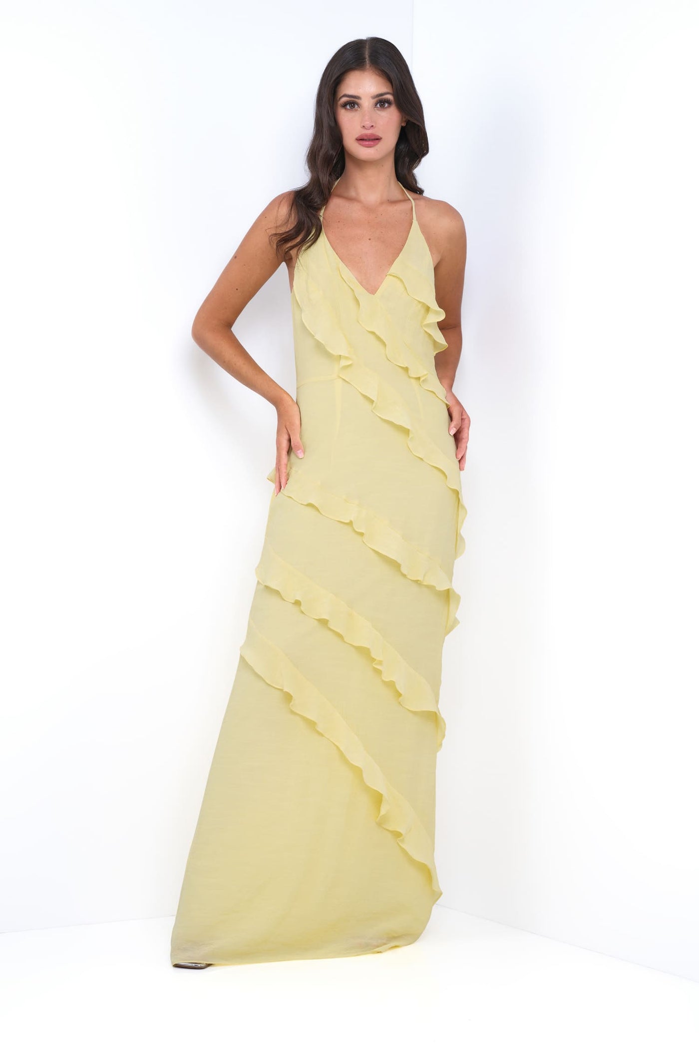 Woman wearing a yellow evening gown on a white background
