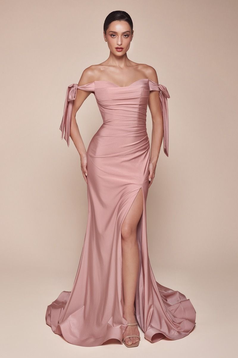Pink off-shoulder gown with ribbon details on a beige background