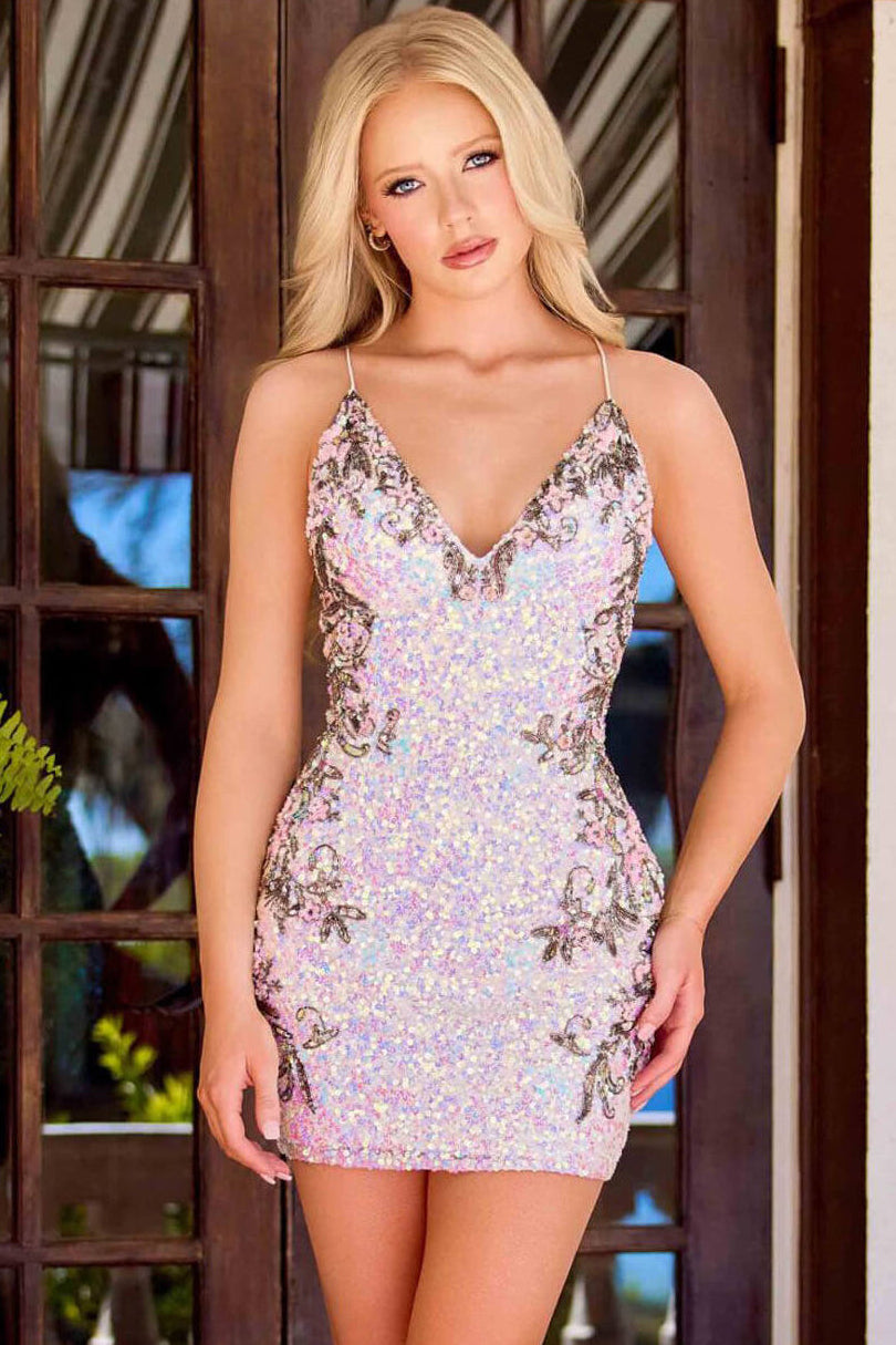 Woman wearing a sequin dress standing in front of a decorative door.