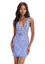 Woman wearing a blue beaded dress on a white background