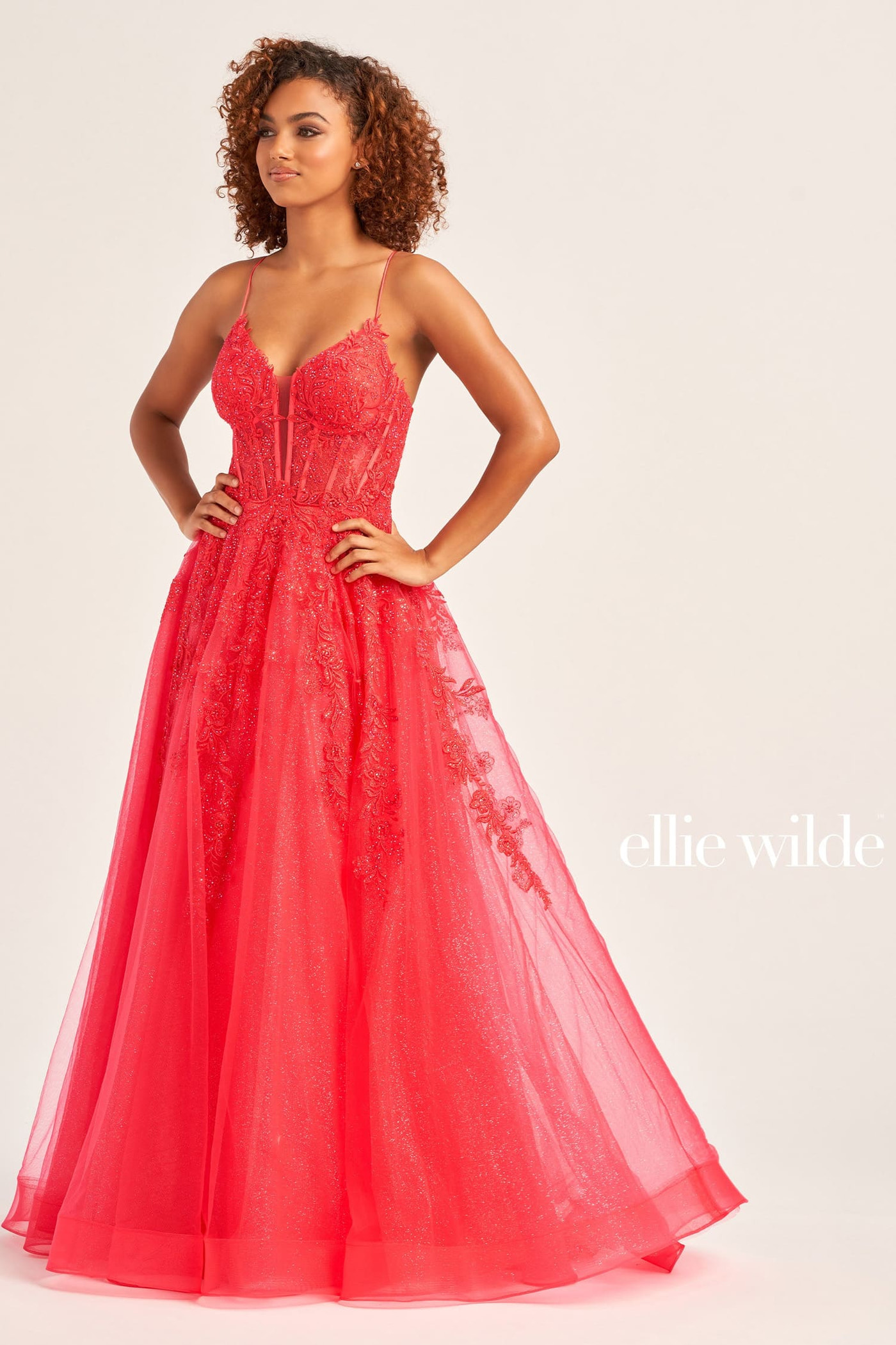 Woman wearing a red evening gown with 'ellie wilde' branding on a white background