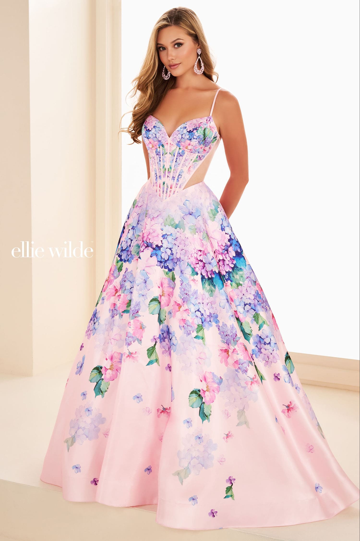 Woman wearing a floral pink dress with a plain background