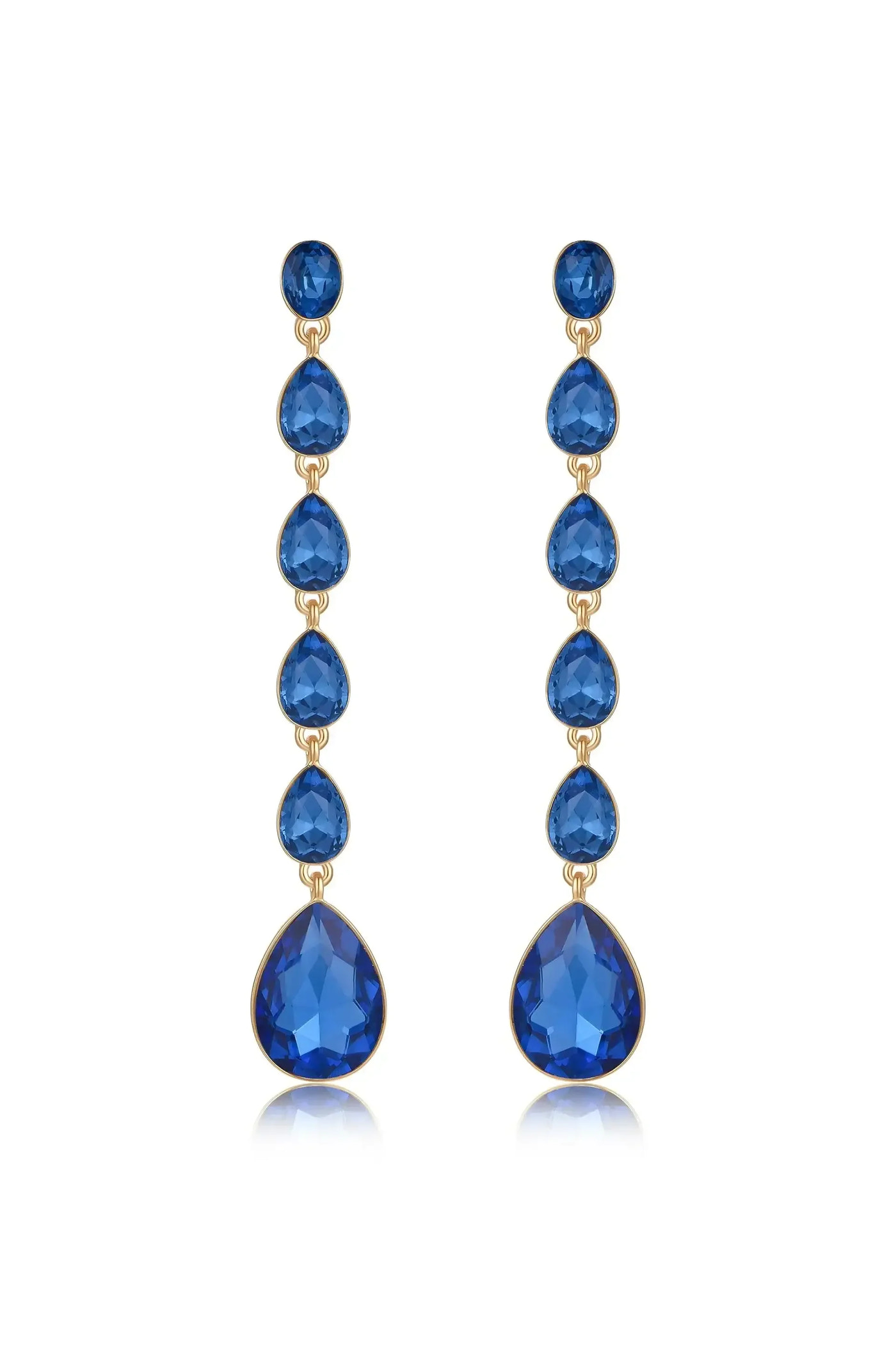 Dangle earrings feature multiple blue gemstones in teardrop and round shapes, strung together in a vertical arrangement. They are set against a plain white background, enhancing their elegance.