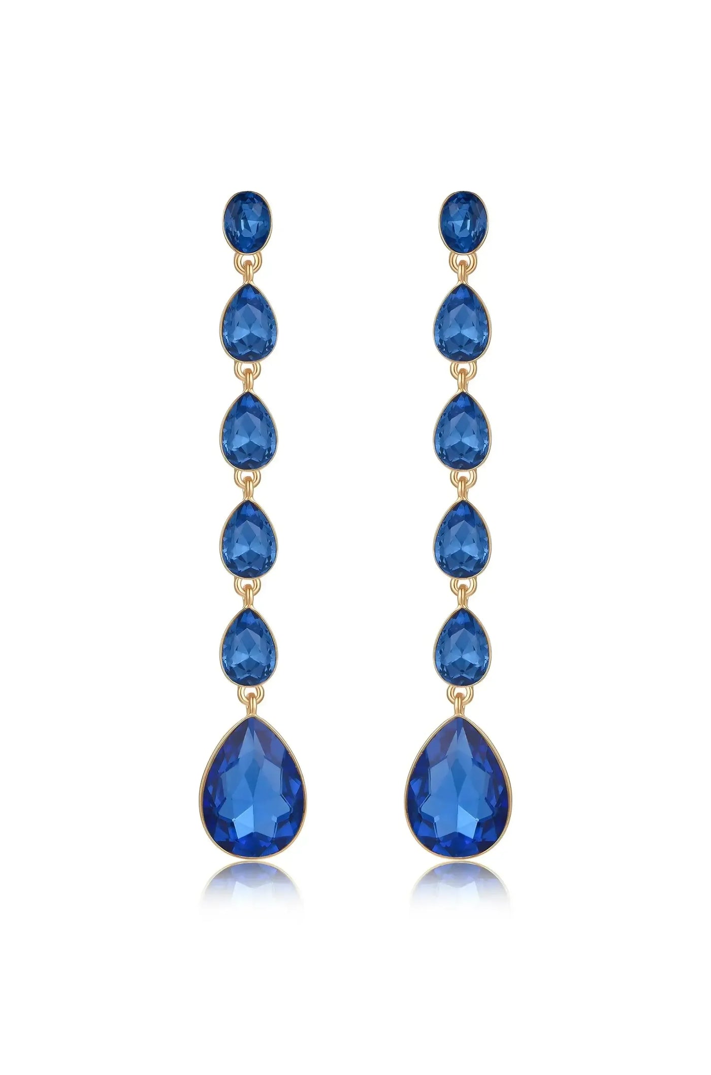 Dangle earrings feature multiple blue gemstones in teardrop and round shapes, strung together in a vertical arrangement. They are set against a plain white background, enhancing their elegance.