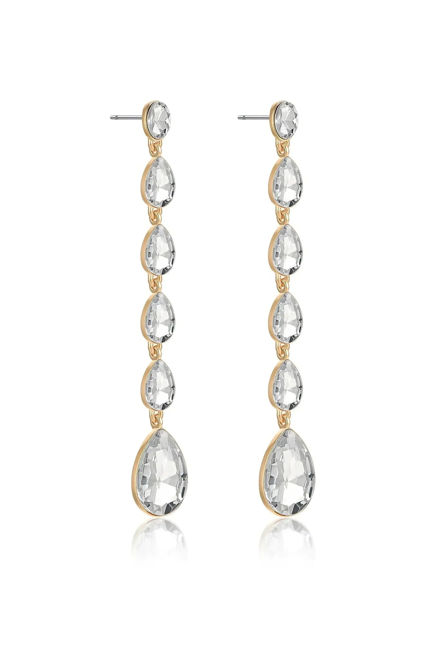 Long, elegant earrings made of transparent, teardrop-shaped stones hang from thin posts. The stones are connected by gold-toned metal links, reflecting light in a simple, stylish design.