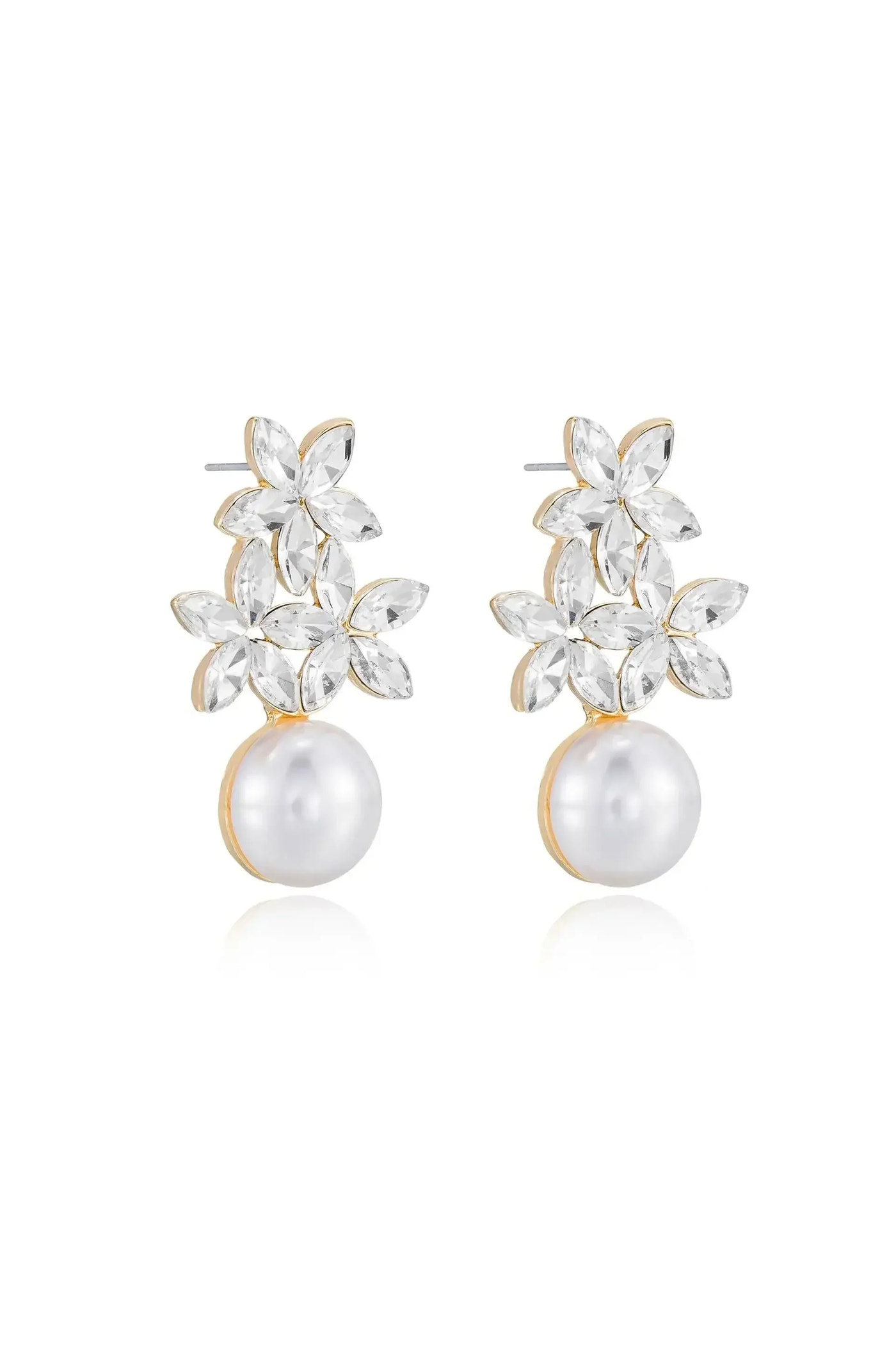 Elegant earrings featuring a floral design made of clear gemstones atop a large, lustrous pearl. They are displayed against a plain white background, highlighting their intricate details and shine.