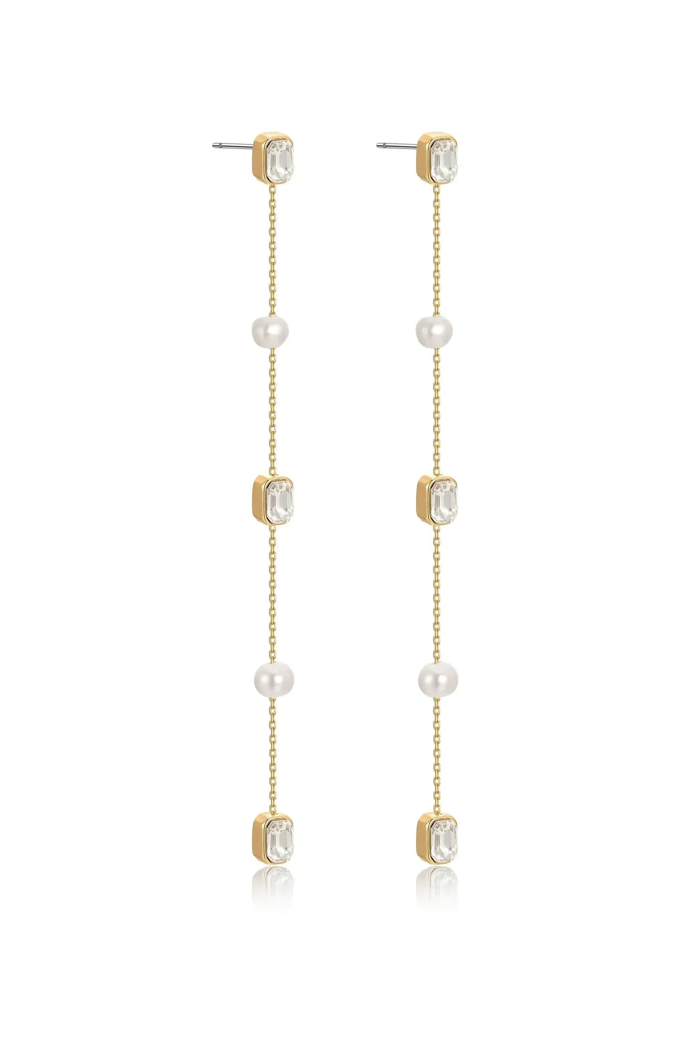 Long, elegant earrings feature alternating gold, crystal, and pearl elements. They dangle gracefully, reflecting light, suitable for formal or festive occasions. The background is neutral, emphasizing the earrings' design.