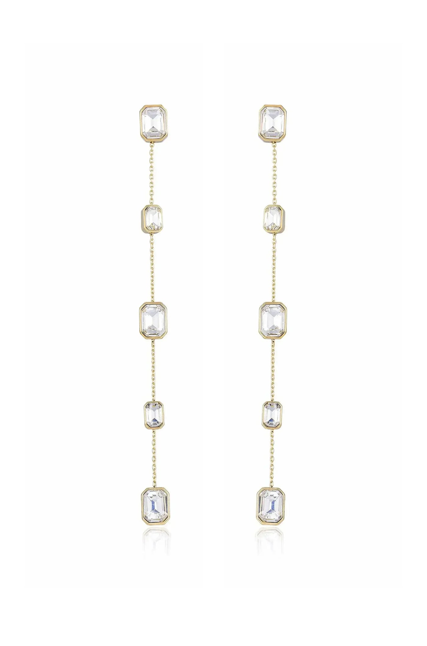 Gold dangle earrings feature multiple clear octagonal crystals linked by delicate chains, showcasing elegance and shine. They stand against a neutral background, highlighting their refined design and sparkle.