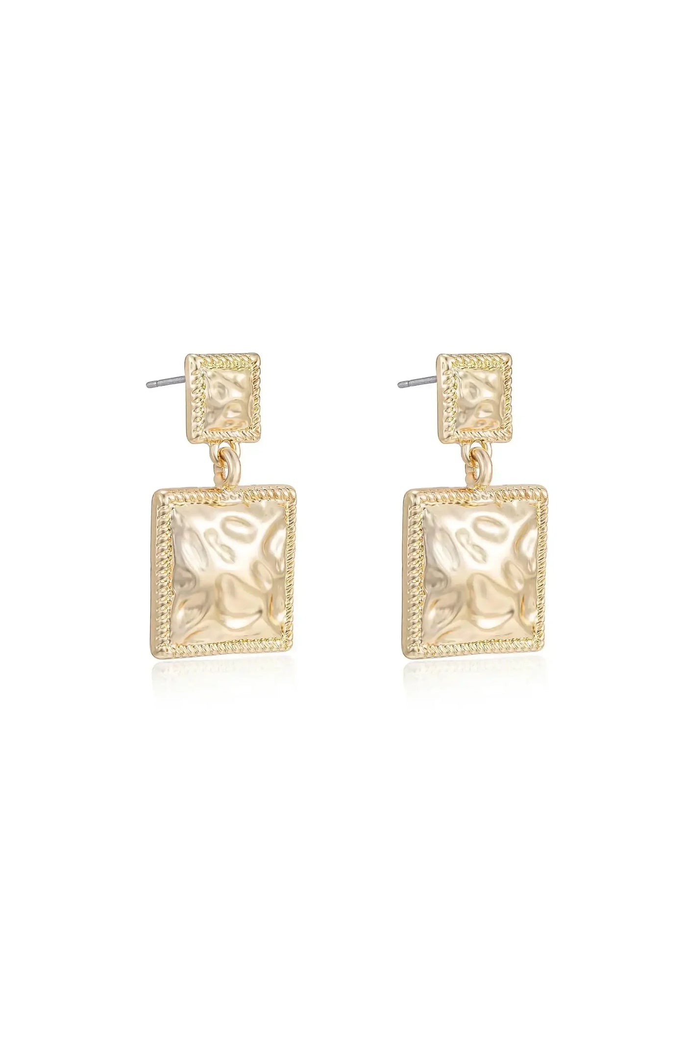 Gold earrings hang vertically, featuring square shapes with a textured surface. The shiny metal reflects light, highlighting its smooth and intricate design against a plain white background.
