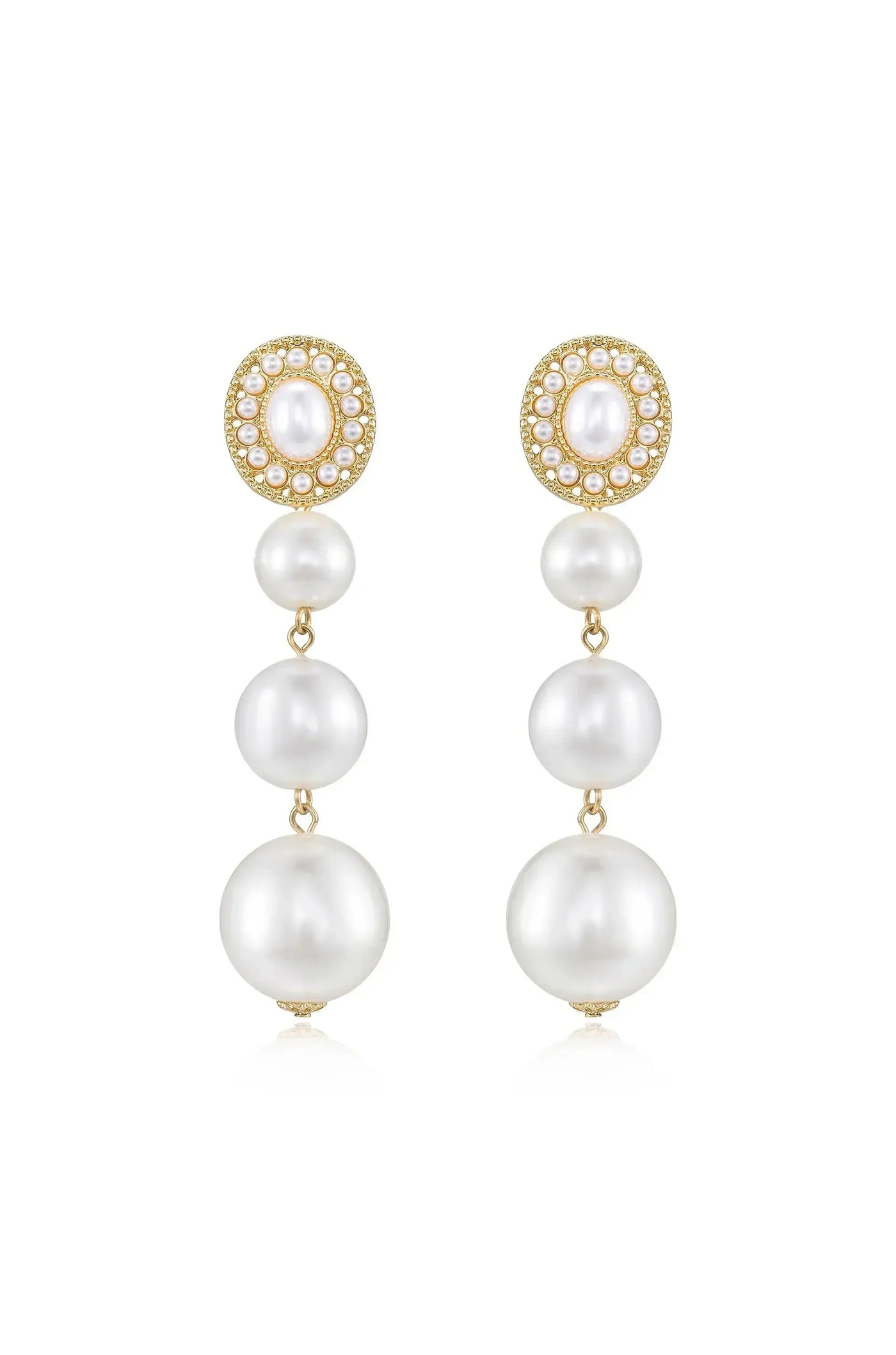 Elegant dangle earrings feature a cluster of four cascading white pearls, topped with a round, bejeweled gold setting. They reflect light, suggesting a formal or luxurious context.