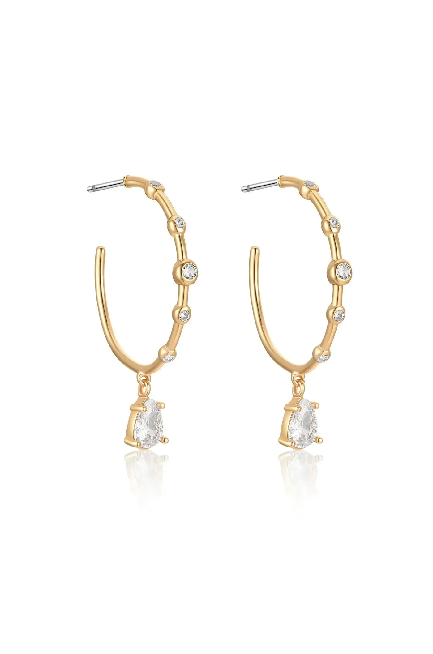Gold hoop earrings feature a bamboo-like design with small clear stones embedded. Each earring has a pear-shaped crystal hanging from the bottom, reflecting light against a simple background.
