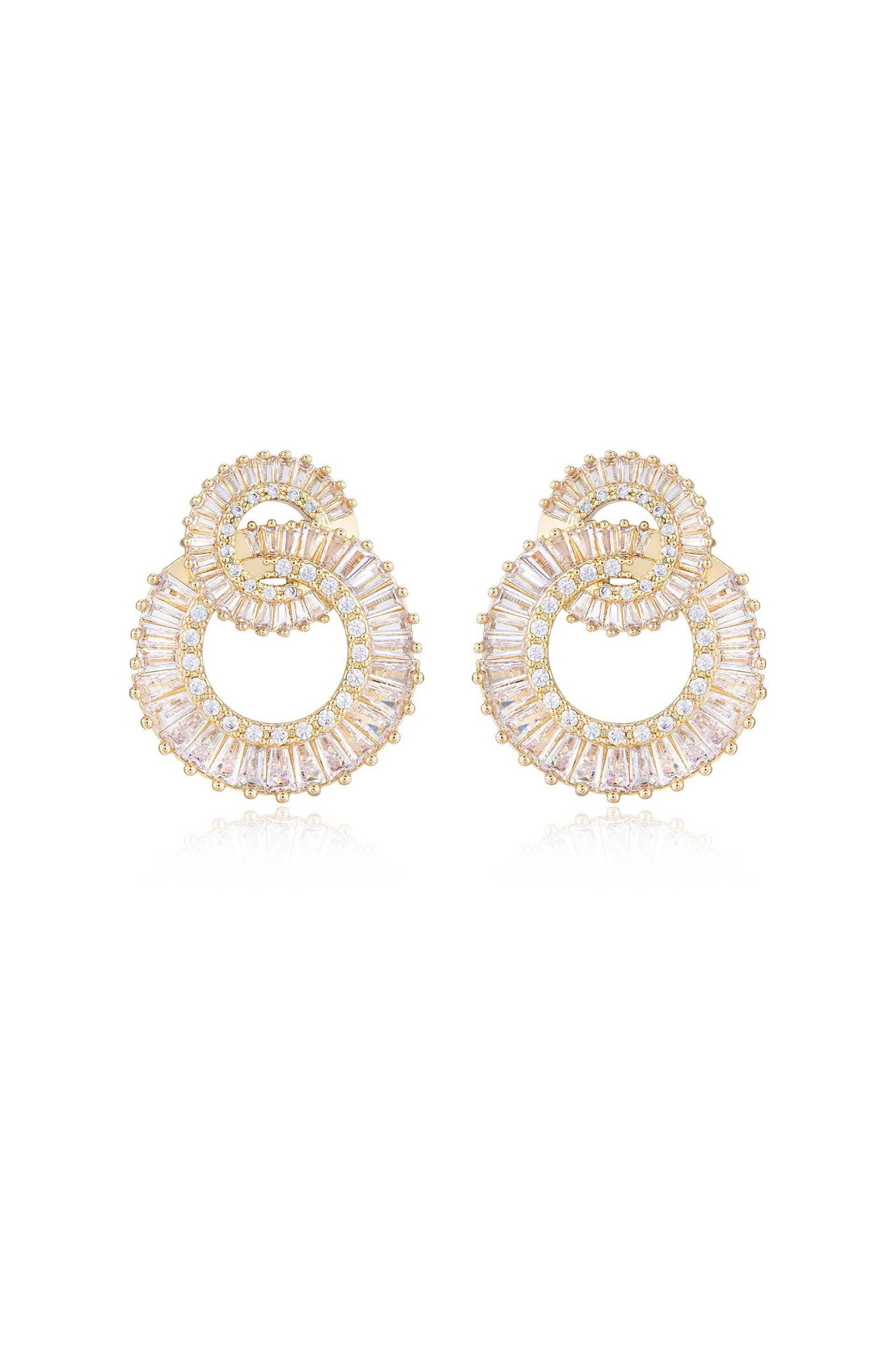 Golden hoop earrings with intricate patterns feature a spiral design filled with sparkling gemstones. They are displayed on a reflective surface, enhancing their elegance and shine.