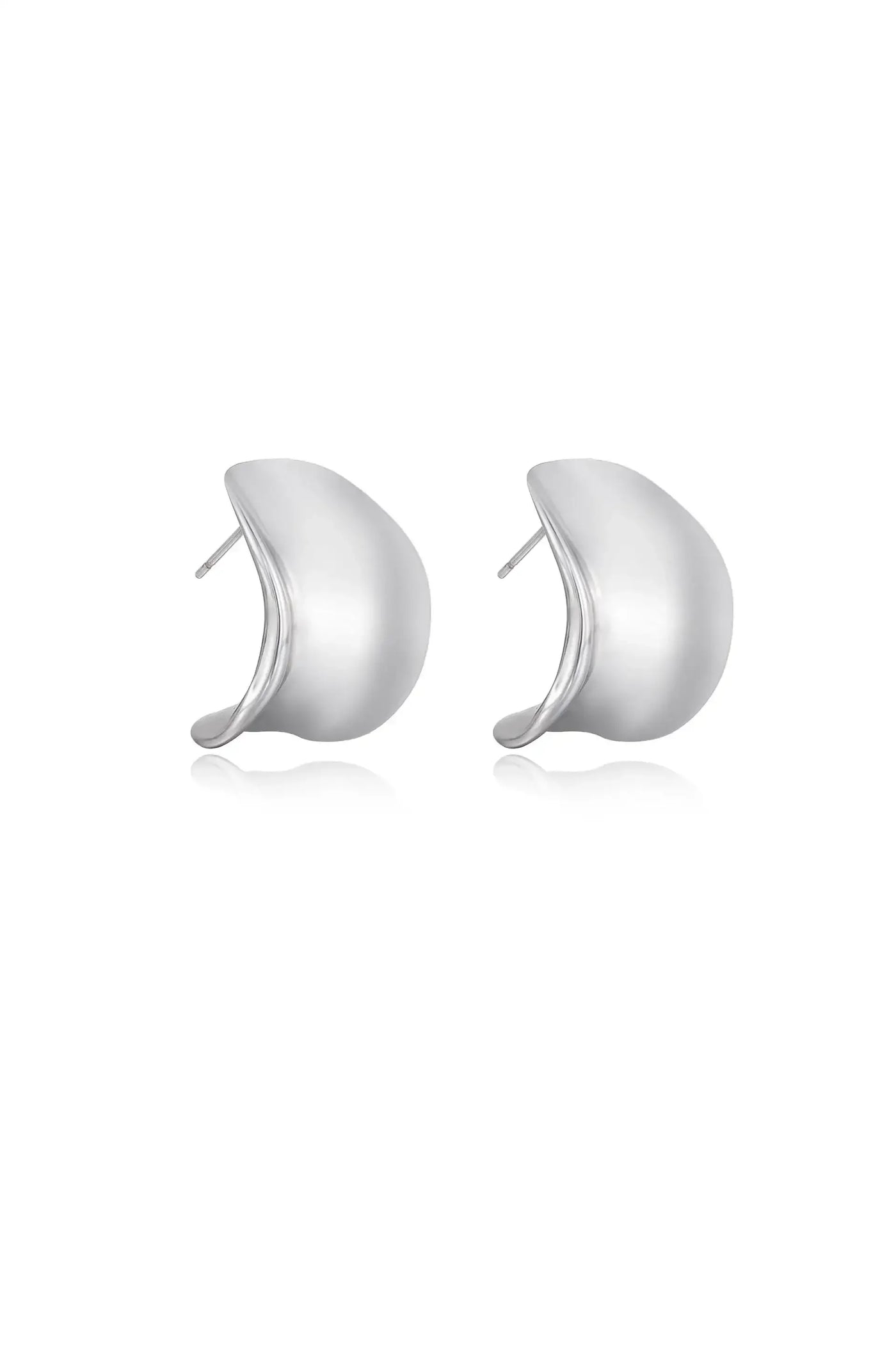 Two silver earrings are displayed together, showcasing a smooth, curved design. They rest on a white background, reflecting light to emphasize their polished surface and elegant shape.