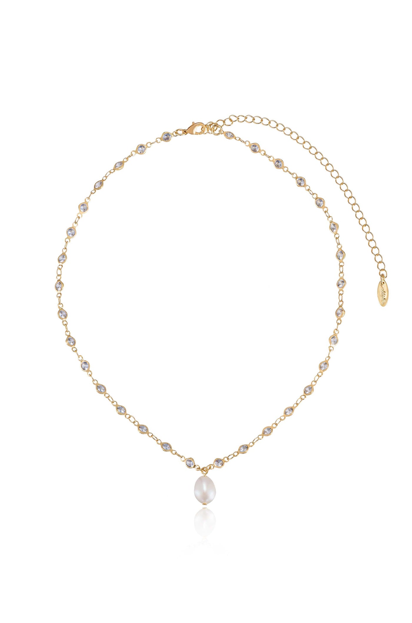 A delicate gold necklace features a series of small gemstones with a central smooth pearl droplet. It is displayed on a white surface, reflecting light elegantly.