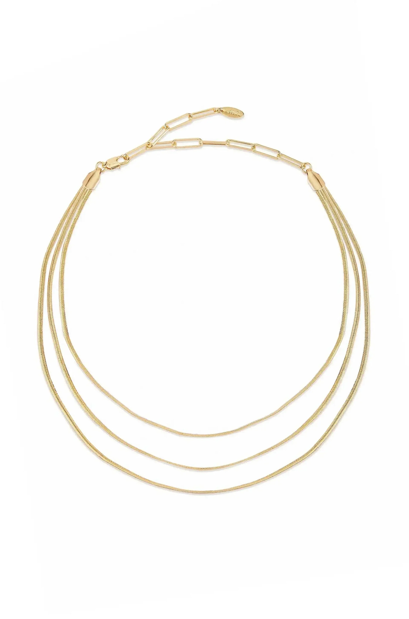 A three-strand gold necklace lies flat, displaying its sleek, shiny texture. It features delicate links and a clasp, set against a plain white background, emphasizing its elegance.