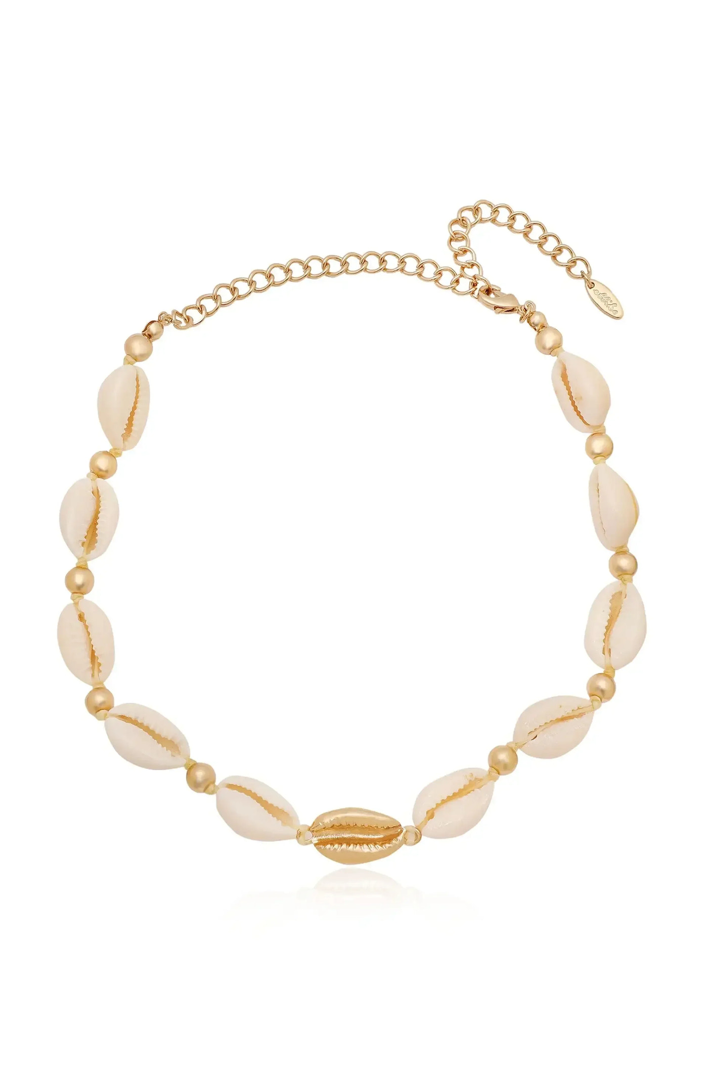 A necklace made of golden beads and cowrie shells, showcasing a combination of natural textures and metallic shine, rests against a light background, emphasizing its elegance and beach-inspired design.