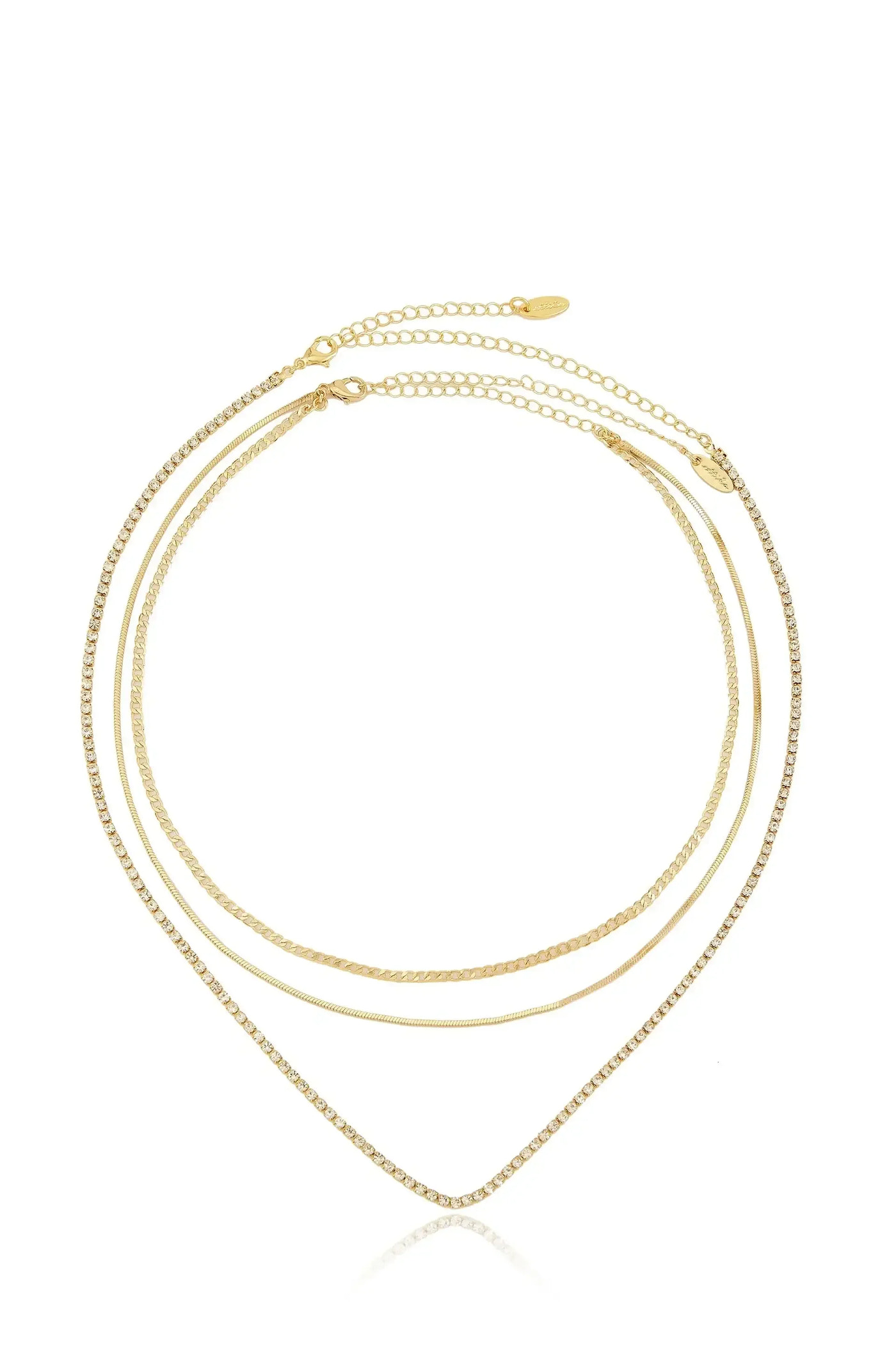 A three-strand gold necklace with varying textures, including a sparkling chain, drapes elegantly in a V shape, reflecting on a clean, white background that enhances its shine.